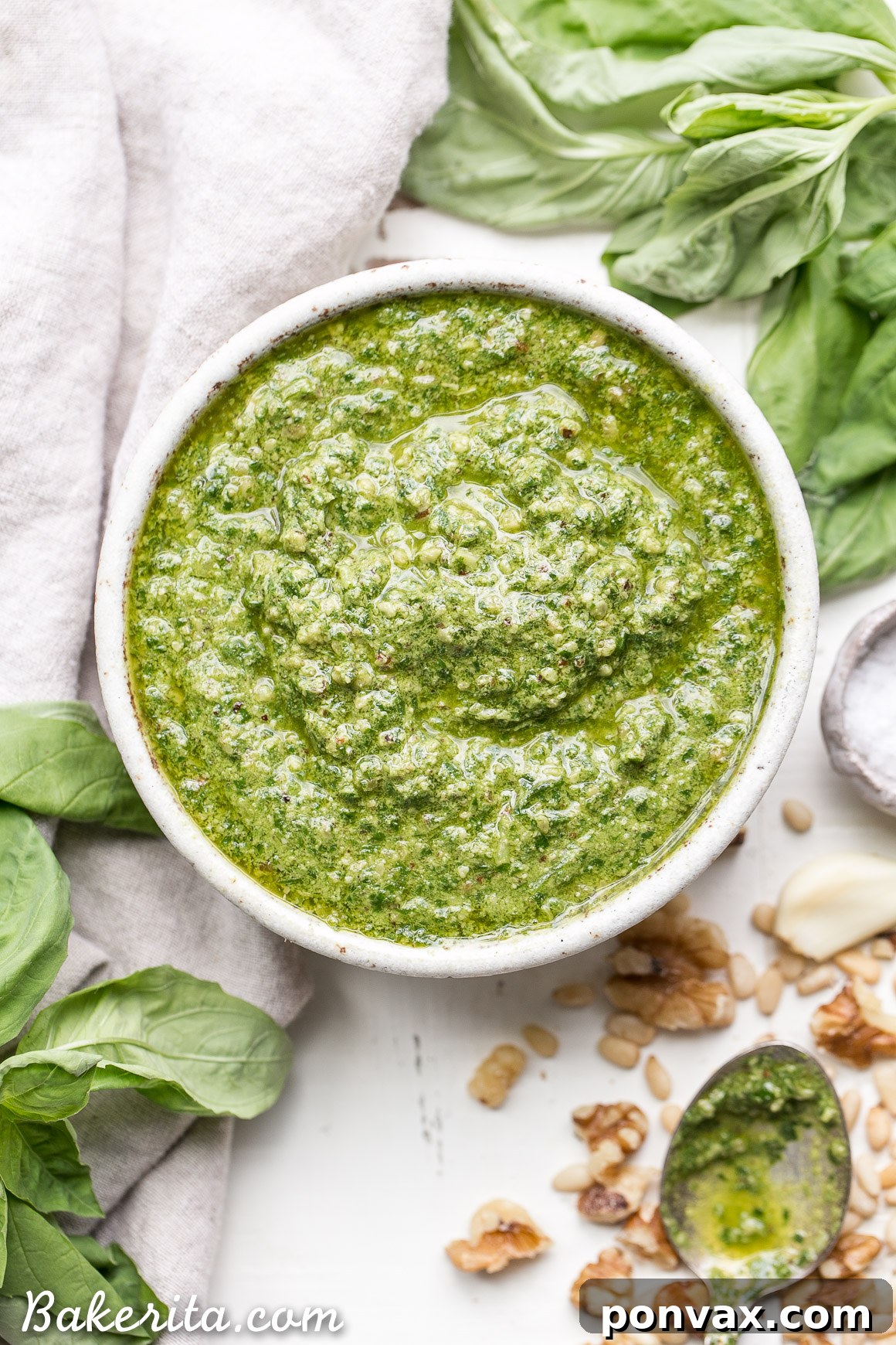 This Spinach Basil Pesto is loaded with bright herby flavor and made in just a few minutes. You won't miss the cheese in this paleo, vegan + Whole30-friendly pesto. It will make any meal more flavorful, whether it's tossed with pasta, enjoyed with your favorite protein, or used as a spread.