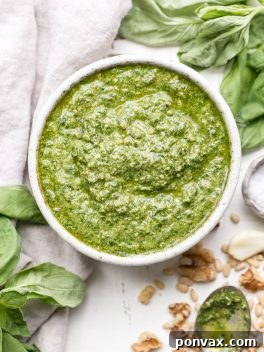 This Spinach Basil Pesto is loaded with bright herby flavor and made in just a few minutes. You won't miss the cheese in this paleo, vegan + Whole30-friendly pesto. It will make any meal more flavorful, whether it's tossed with pasta, enjoyed with your favorite protein, or used as a spread.