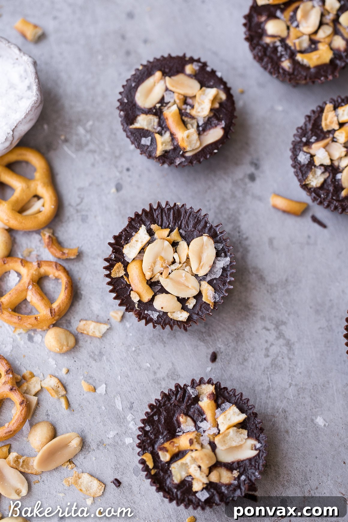 Better Than Take 5 Peanut Butter Pretzel Cups 4 A collection of freshly made Chocolate Pretzel Peanut Butter Cups in a mini muffin tin, ready to be chilled.