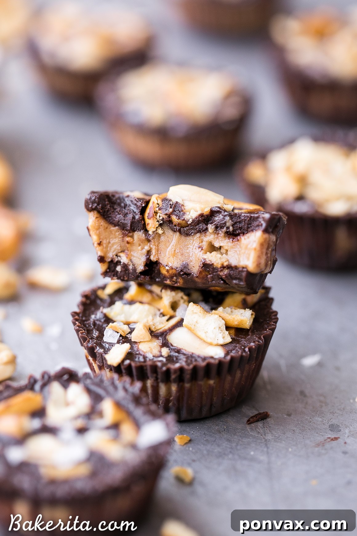 Better Than Take 5 Peanut Butter Pretzel Cups 6 A close-up shot of a single Chocolate Pretzel Peanut Butter Cup, perfectly formed and topped with garnishes, presented on a wooden surface.