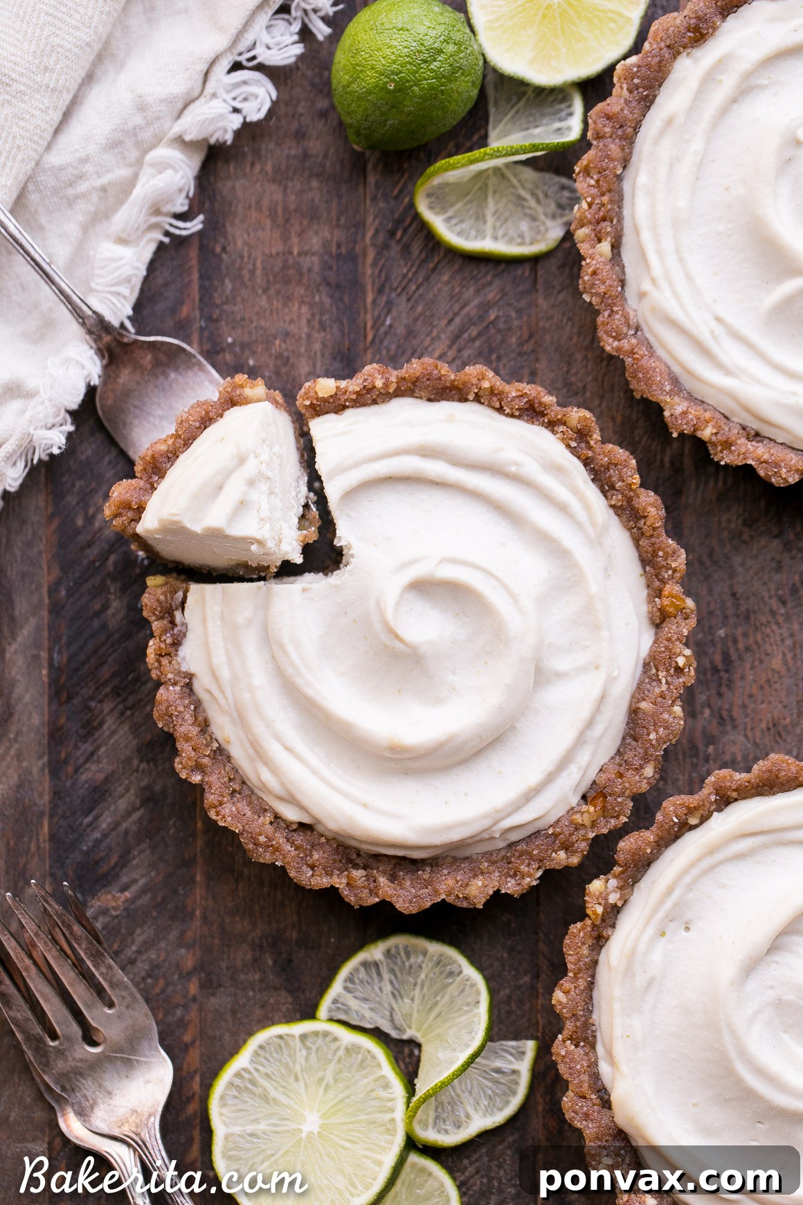 Refreshing Gluten-Free & Vegan No-Bake Lime Tarts 4 Individual No-Bake Lime Tarts arranged beautifully, garnished with fresh lime slices and zest. A visually appealing and healthy dessert option.