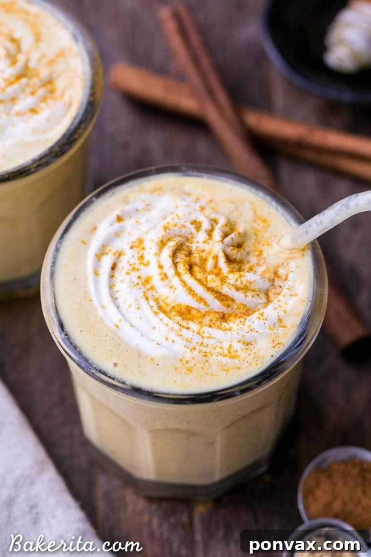 Close-up of a refreshing Golden Milkshake with turmeric, ginger, and cinnamon, showing its vibrant color and inviting texture. Vegan and healthy beverage.