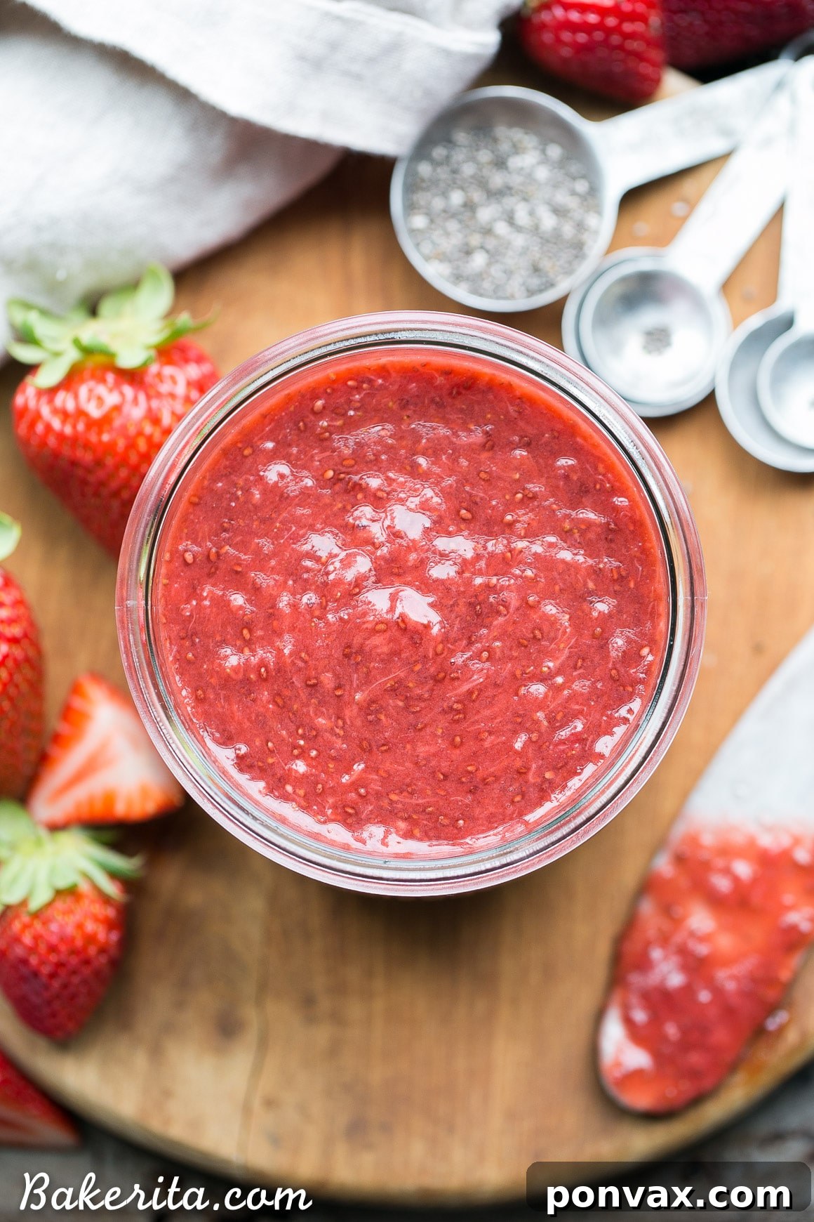 Luscious Paleo Vegan Strawberry Chia Jam 2 Freshly made strawberry chia jam in a jar, showcasing its vibrant red color and natural texture.