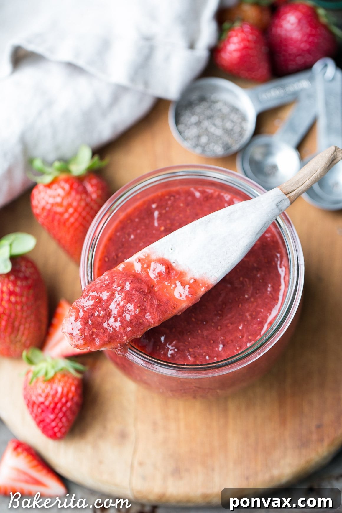 Luscious Paleo Vegan Strawberry Chia Jam 4 A spoonful of vibrant strawberry chia jam ready to be served.