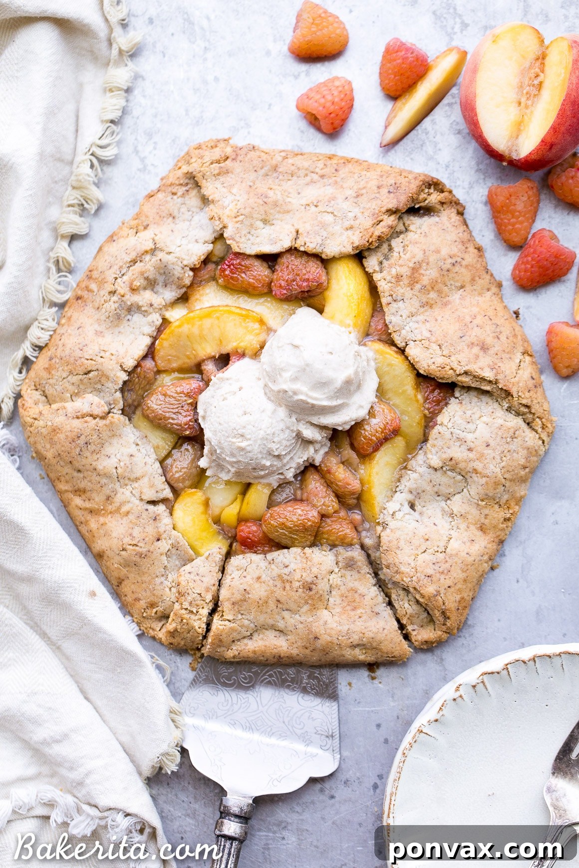 A stunning Vegan Peach Raspberry Galette with a golden, flaky crust and abundant fresh fruit filling, ready to be served.