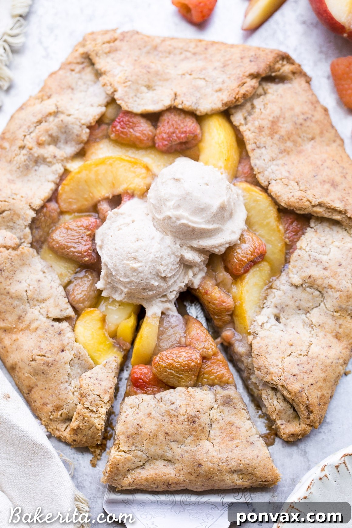The rolled-out vegan gluten-free galette crust on parchment paper, delicately thin and ready for the vibrant fruit filling.