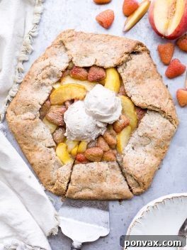 The final baked Vegan Peach Raspberry Galette, a perfect summer dessert, showcasing its golden crust and vibrant fruit.