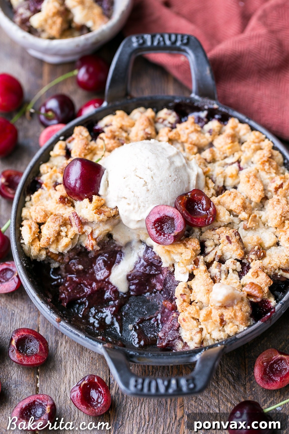 A close-up shot of a grain-free cherry crisp with a golden, crunchy topping, ready to be served. It highlights the healthy, gluten-free, paleo, and vegan attributes of the dessert.