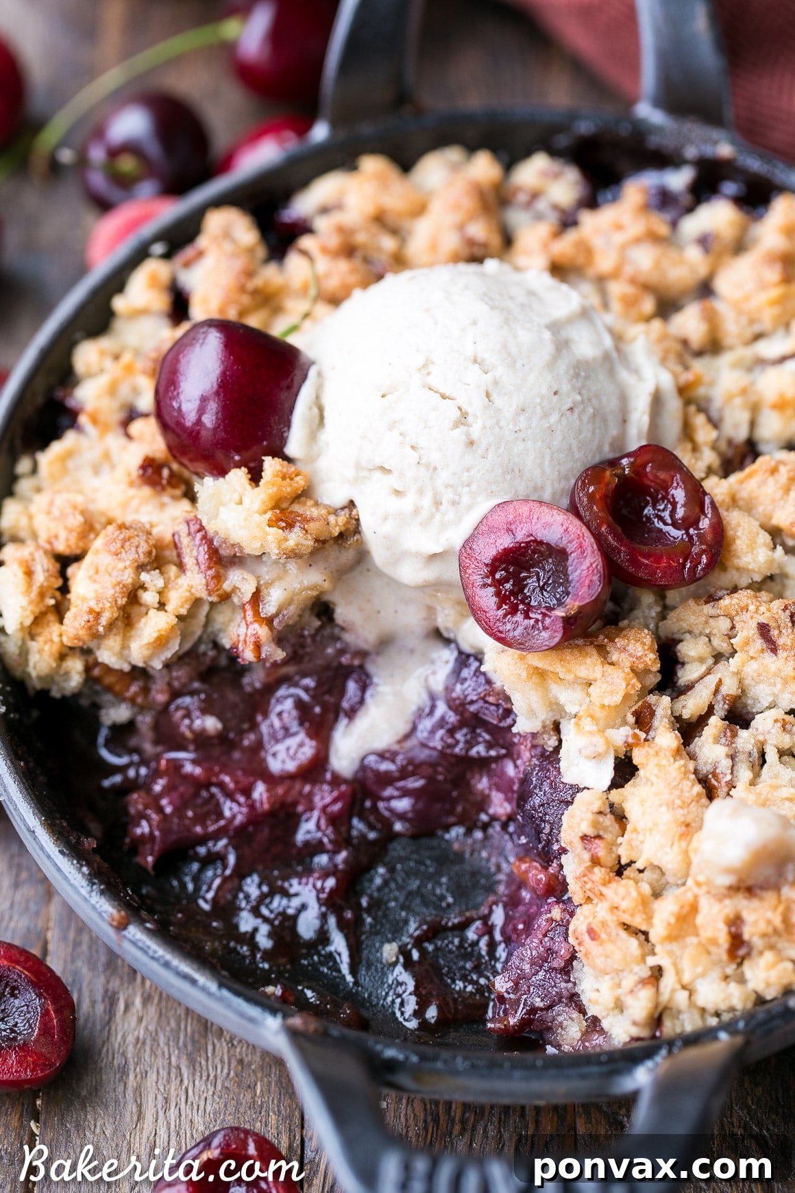 An overhead shot of the grain-free cherry crisp in a baking dish, garnished with fresh mint or a dusting of powdered sugar, emphasizing its delicious appeal.