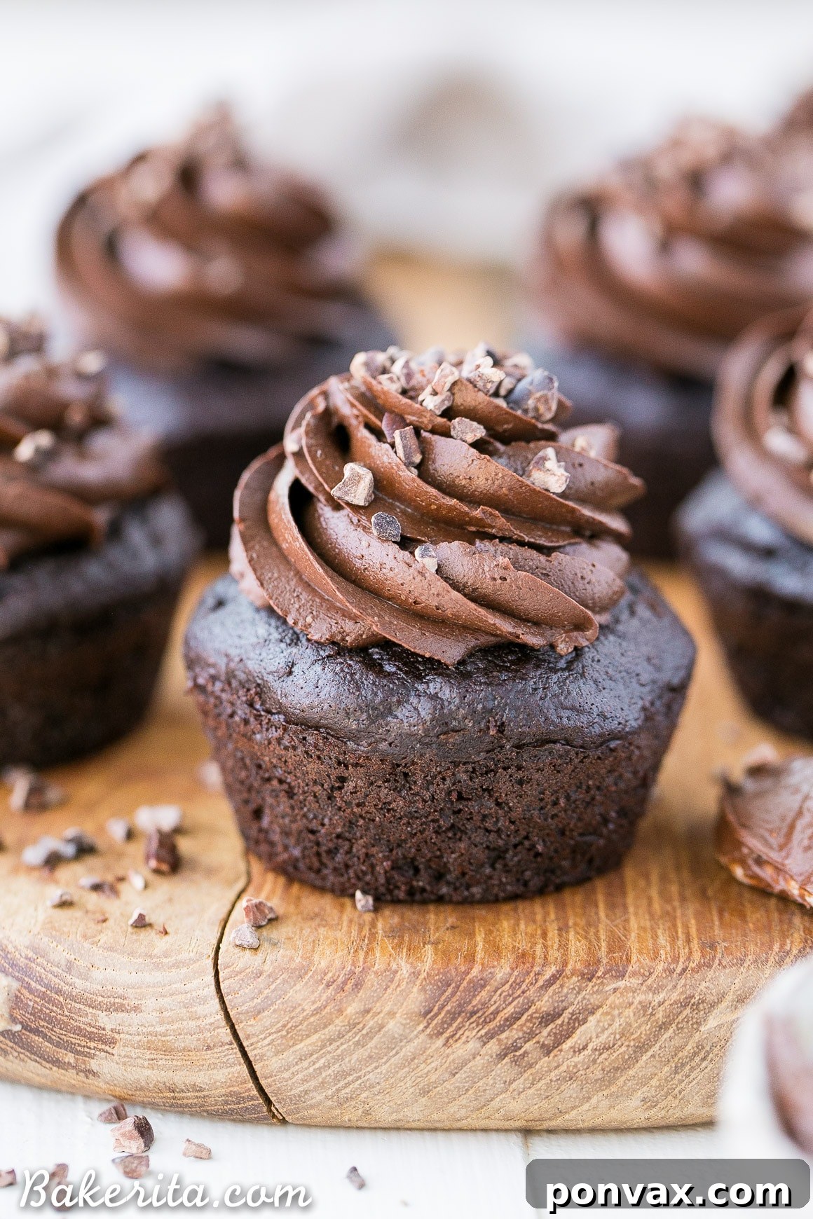 Moist, chocolatey cupcakes made with hidden zucchini, topped with a luscious Paleo chocolate frosting – a healthy dessert option.
