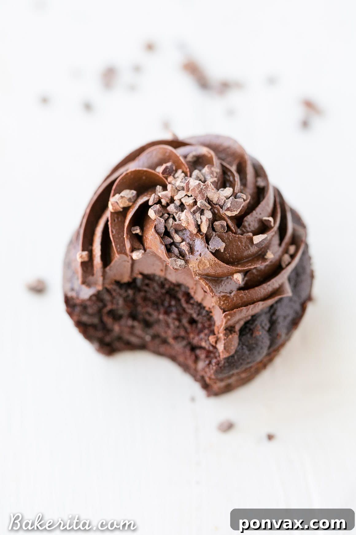 Close-up of a Gluten-Free Chocolate Zucchini Cupcake with creamy Paleo Chocolate Frosting, highlighting its moist texture.