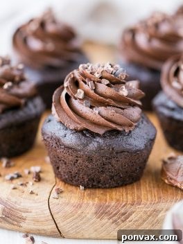 These Paleo Chocolate Zucchini Cupcakes are topped with a rich and fudgy Paleo Chocolate Frosting! You'd never guess there are veggies packed into these super moist and chocolatey cupcakes.