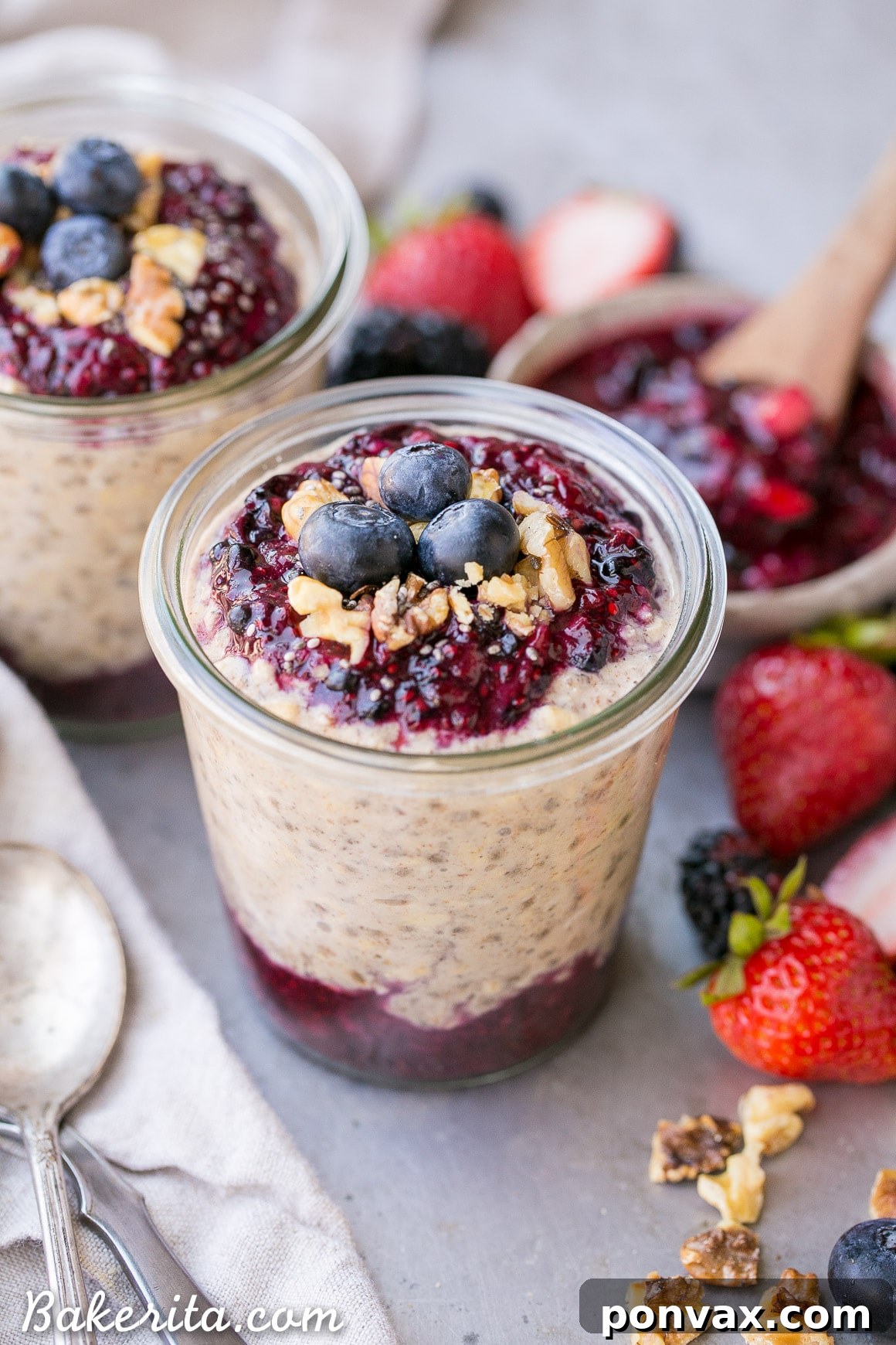 A spoonful of Superfood Overnight Oats with a swirl of Berry Chia Jam, ready to be enjoyed.