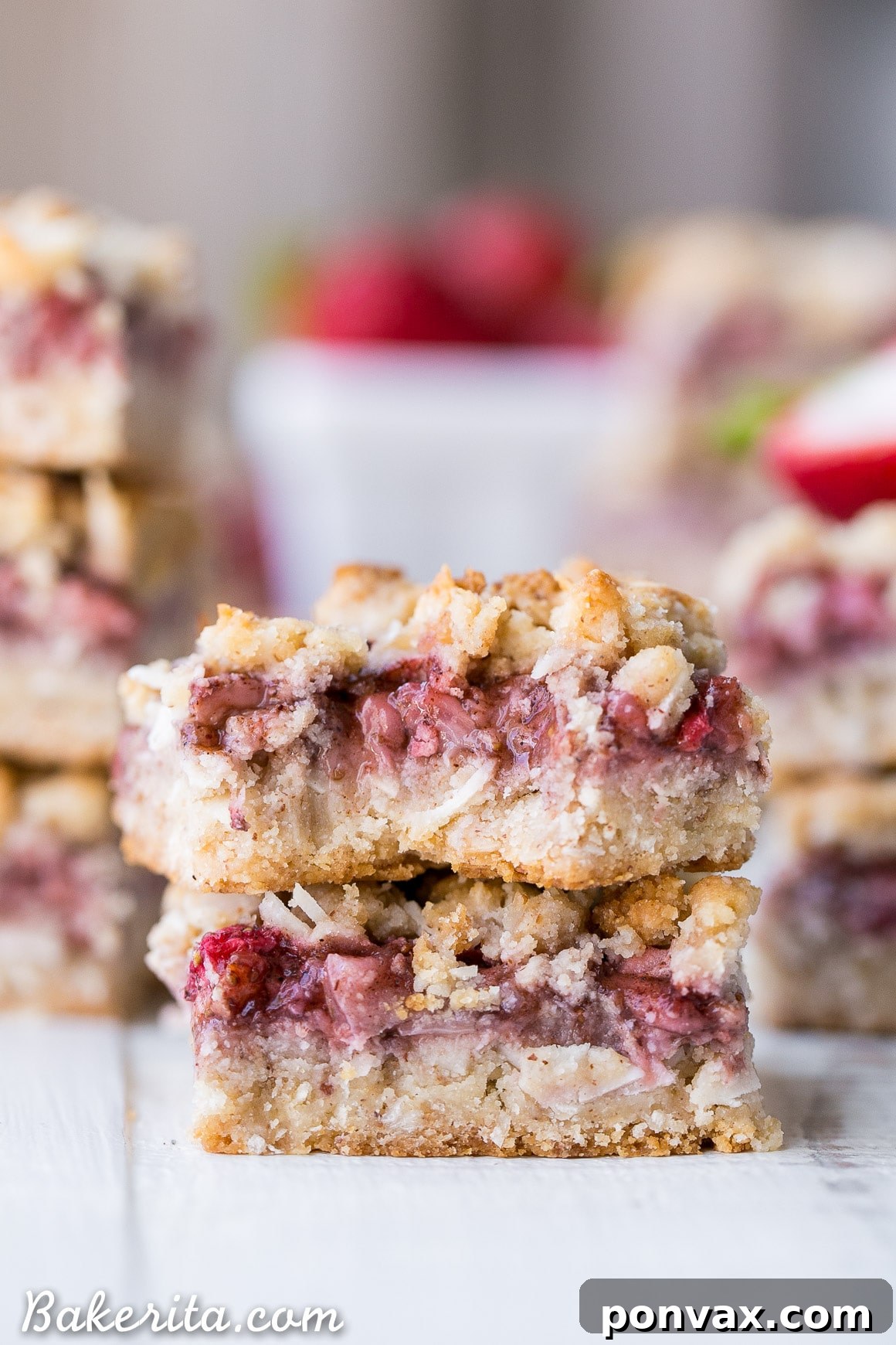 Ingredients laid out for making Strawberry Crumble Bars, including fresh strawberries and flaked coconut.