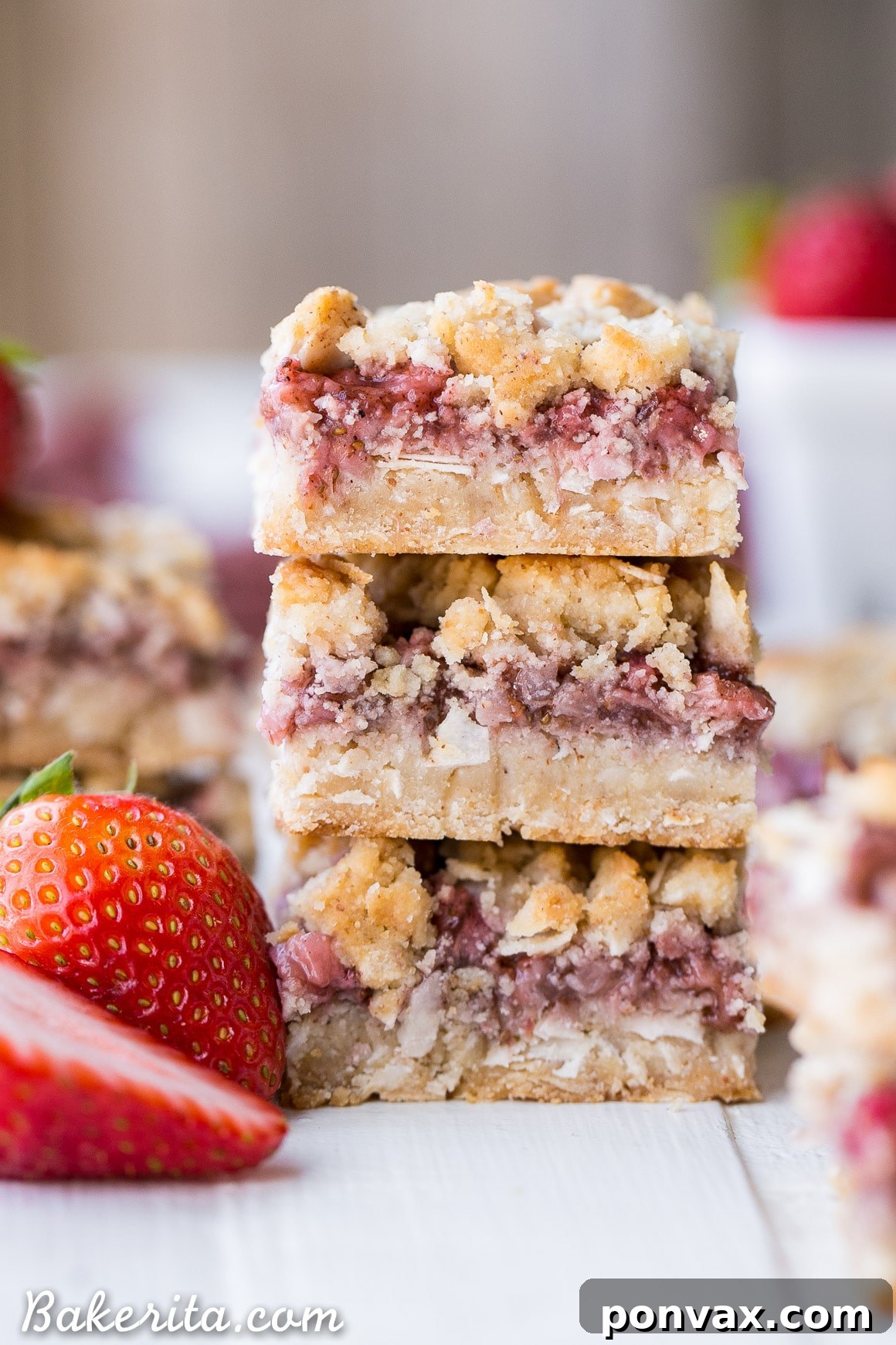 Sliced Strawberry Crumble Bars on a cooling rack, showing the layers of crust, fruit, and crumble.