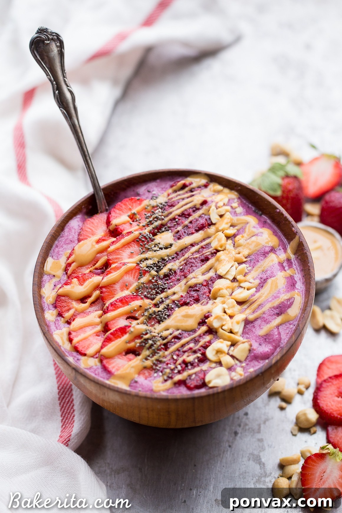 PBJ Smoothie Bowl Vegan Gluten Free 6 Complete your Peanut Butter & Jelly Smoothie Bowl with delicious toppings: homemade berry chia jam, fresh strawberries, chopped roasted peanuts, and a generous peanut butter drizzle. A perfect healthy, vegan, and gluten-free breakfast!