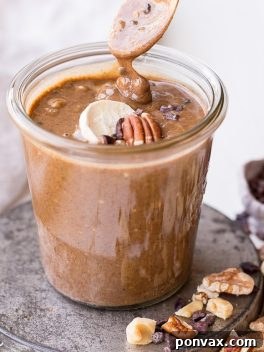 Homemade Banana Nut Butter with Cacao Nibs in a jar, ready to be spread.