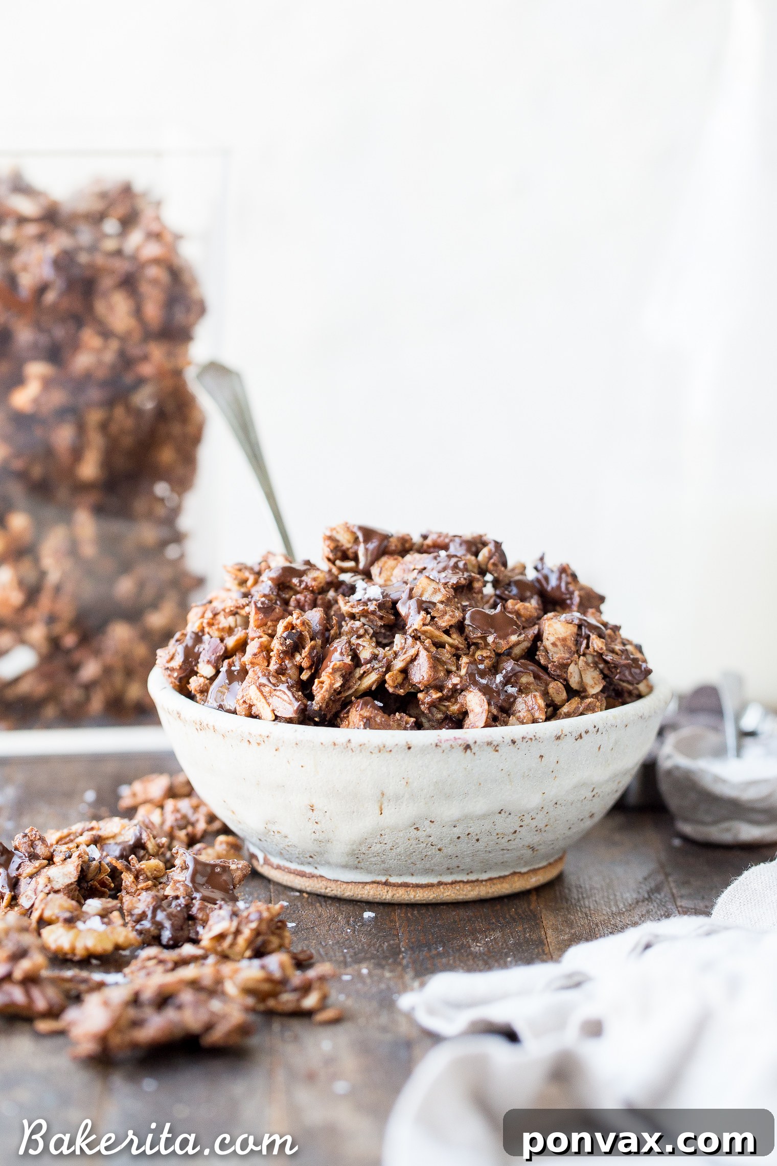A vibrant bowl of Chunky Chocolate Grain-Free Granola with a splash of non-dairy milk, making a perfect, healthy breakfast.