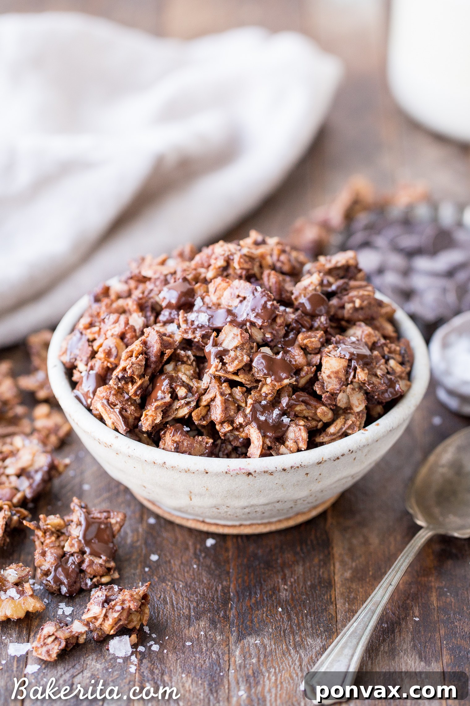 A close-up shot of a large, tempting chunk of chocolate grain-free granola, highlighting its rich texture and natural ingredients.