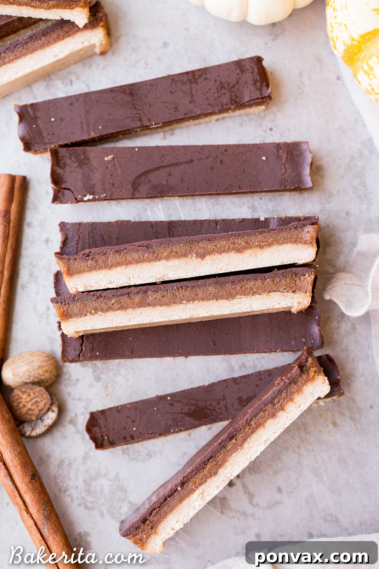 Gluten-Free Vegan Pumpkin Spice Twix Bars 2 Delectable homemade Pumpkin Spice Twix Bars, a gluten-free, paleo, and vegan fall dessert, beautifully arranged.