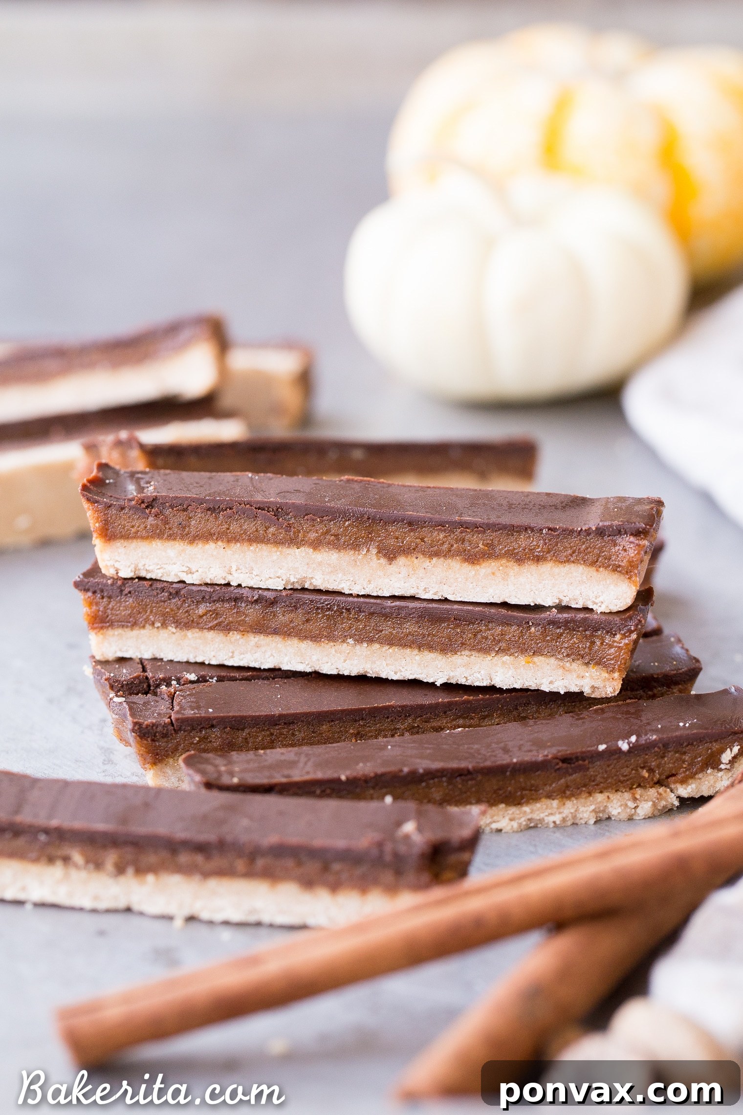 Gluten-Free Vegan Pumpkin Spice Twix Bars 5 A close-up of the shortbread crust, showing its firm yet delicate texture and golden-brown edges.