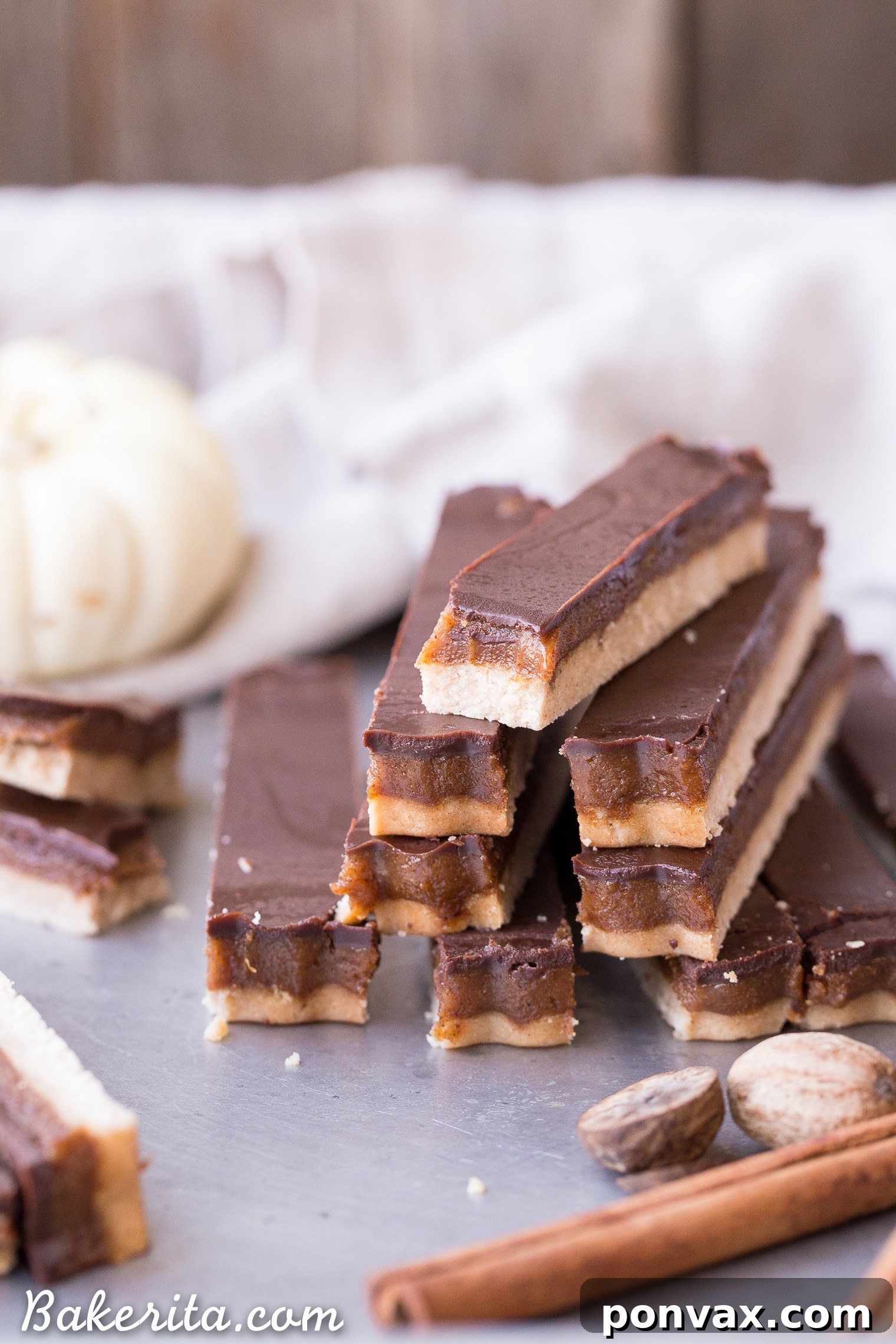 Gluten-Free Vegan Pumpkin Spice Twix Bars 6 A Pumpkin Spice Twix Bar generously coated with a smooth, dark chocolate topping.