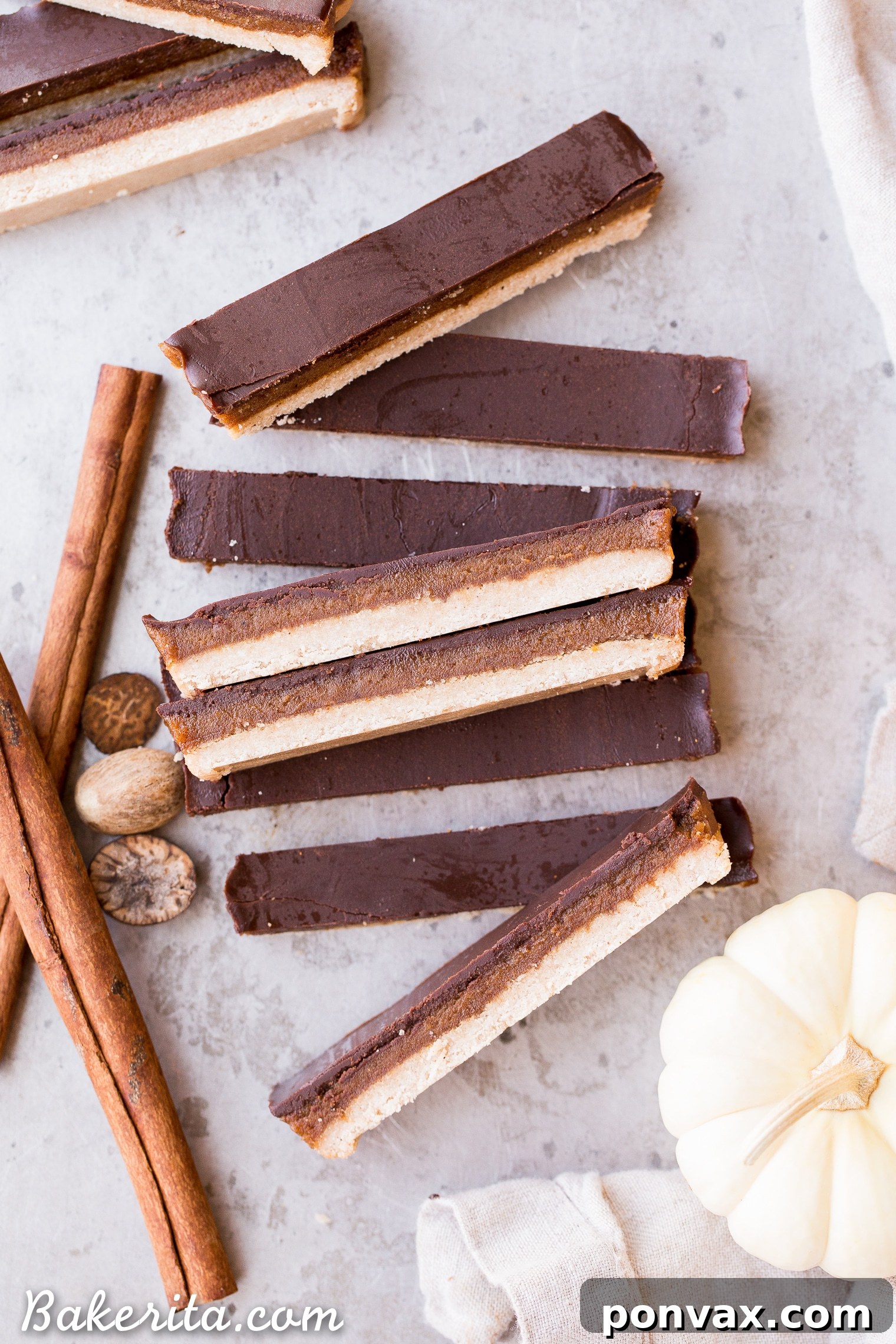 Gluten-Free Vegan Pumpkin Spice Twix Bars 7 A perfectly sliced Pumpkin Spice Twix Bar, showcasing its layers and rich texture, ready for serving.