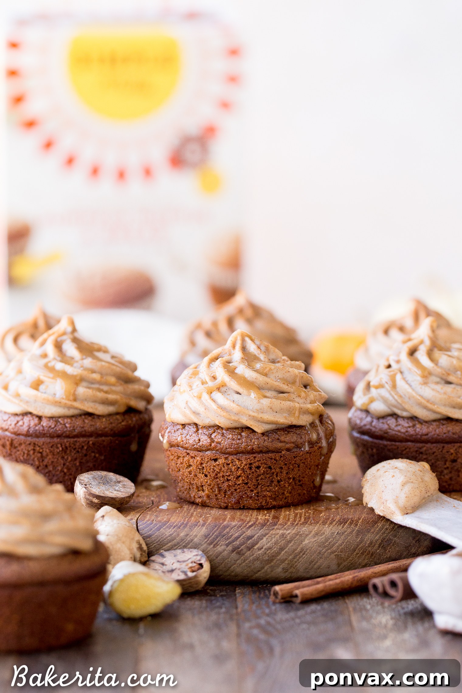 Close-up of a Gluten-Free Pumpkin Chai Cupcake topped with fluffy vegan frosting and a sprinkle of spice