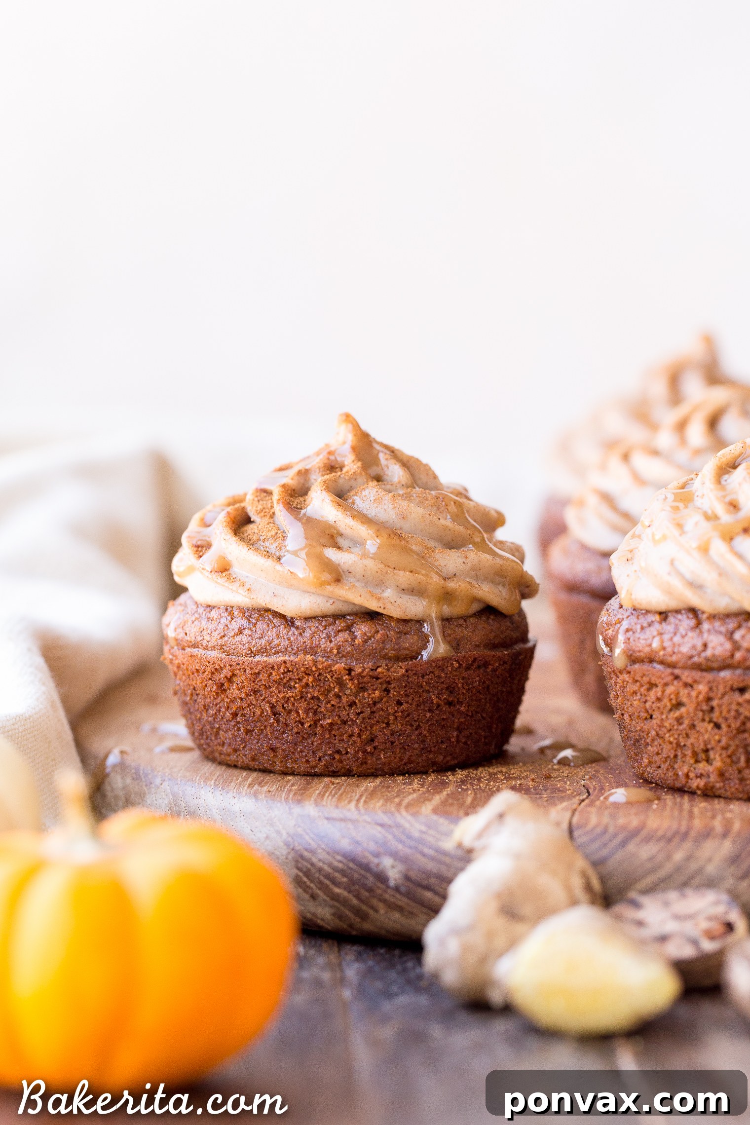 Piped vegan chai frosting on a gluten-free pumpkin cupcake, garnished with spice