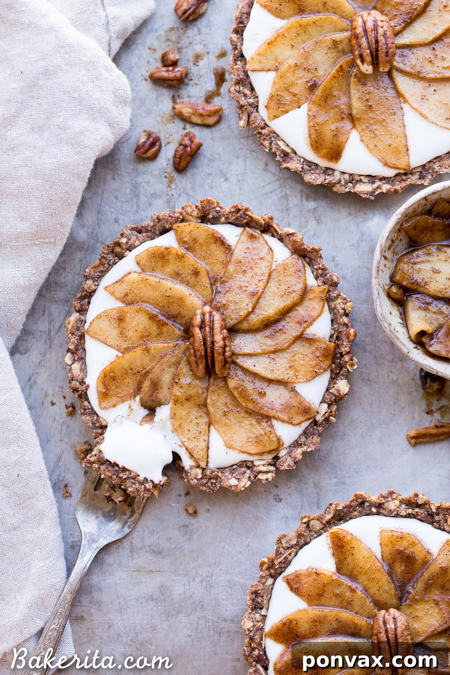 Close-up view of a wholesome Granola Breakfast Tart, showcasing the golden-brown crust, smooth coconut yogurt, and fragrant cinnamon apples. A perfect gluten-free and vegan breakfast option.