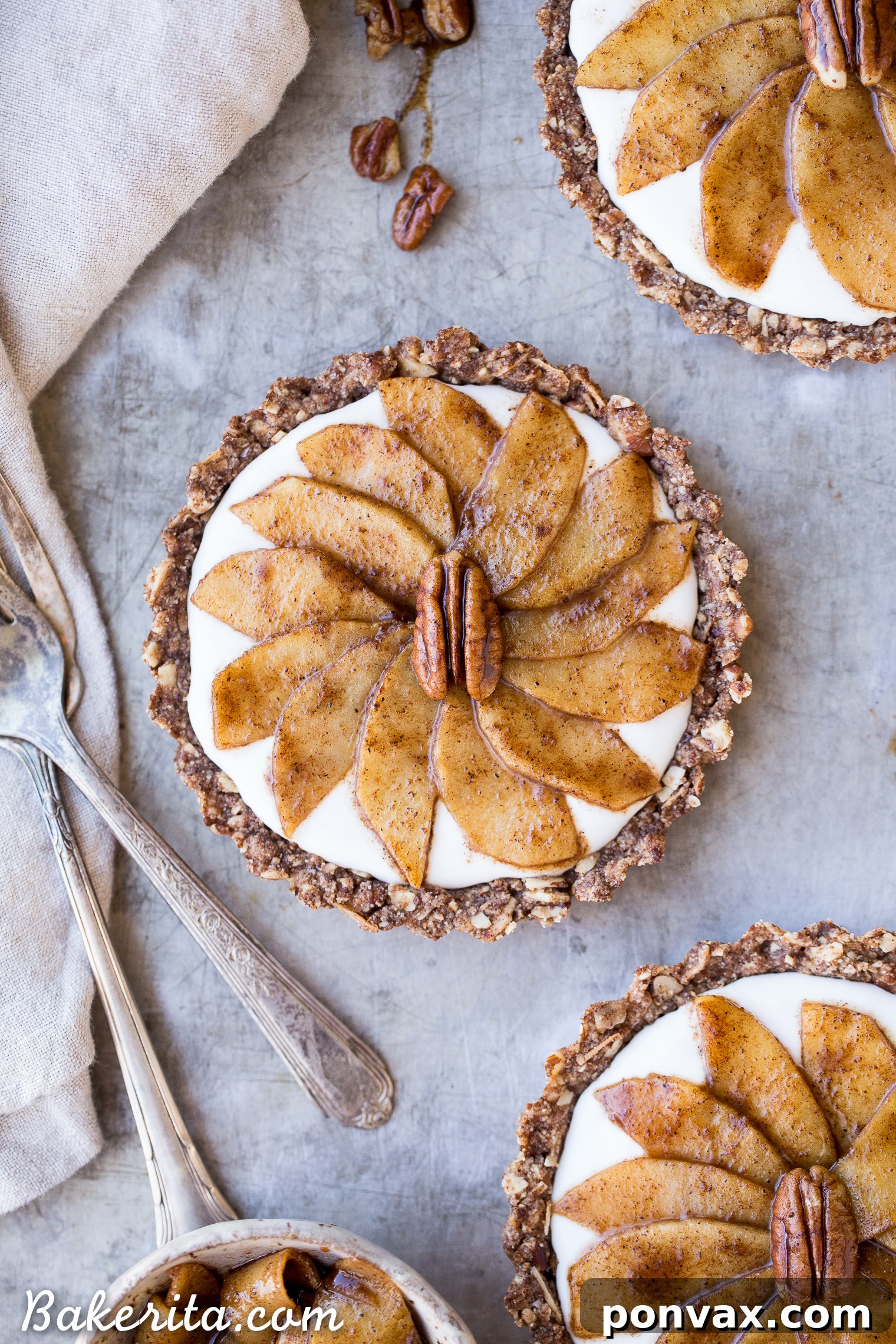 A beautifully plated Granola Breakfast Tart, generously piled with creamy coconut yogurt and a mountain of warm, cinnamon-spiced sautéed apples, ready to be enjoyed.