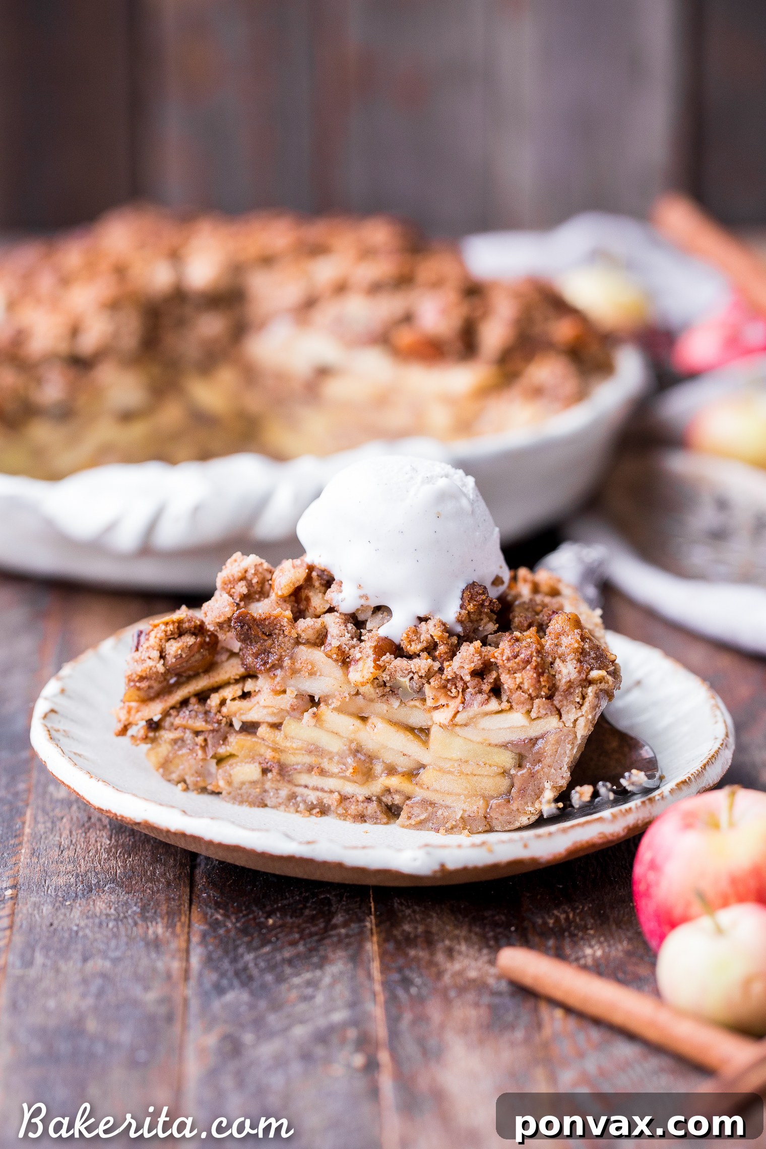 This Apple Crumble Pie is so delicious it's bound to be a holiday dessert staple! This gluten free, paleo + vegan pie is filled with soft, caramelized apples and topped with a nutty, crunchy paleo crumble topping.