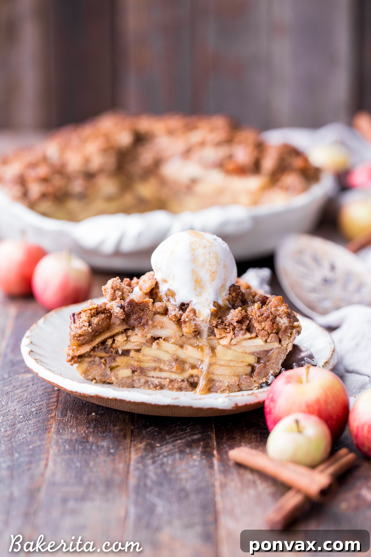 This Apple Crumble Pie is so delicious it's bound to be a holiday dessert staple! This gluten free, paleo + vegan pie is filled with soft, caramelized apples and topped with a nutty, crunchy paleo crumble topping.