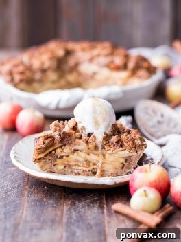This Apple Crumble Pie is so delicious it's bound to be a holiday dessert staple! This gluten free, paleo + vegan pie is filled with soft, caramelized apples and topped with a nutty, crunchy paleo crumble topping.
