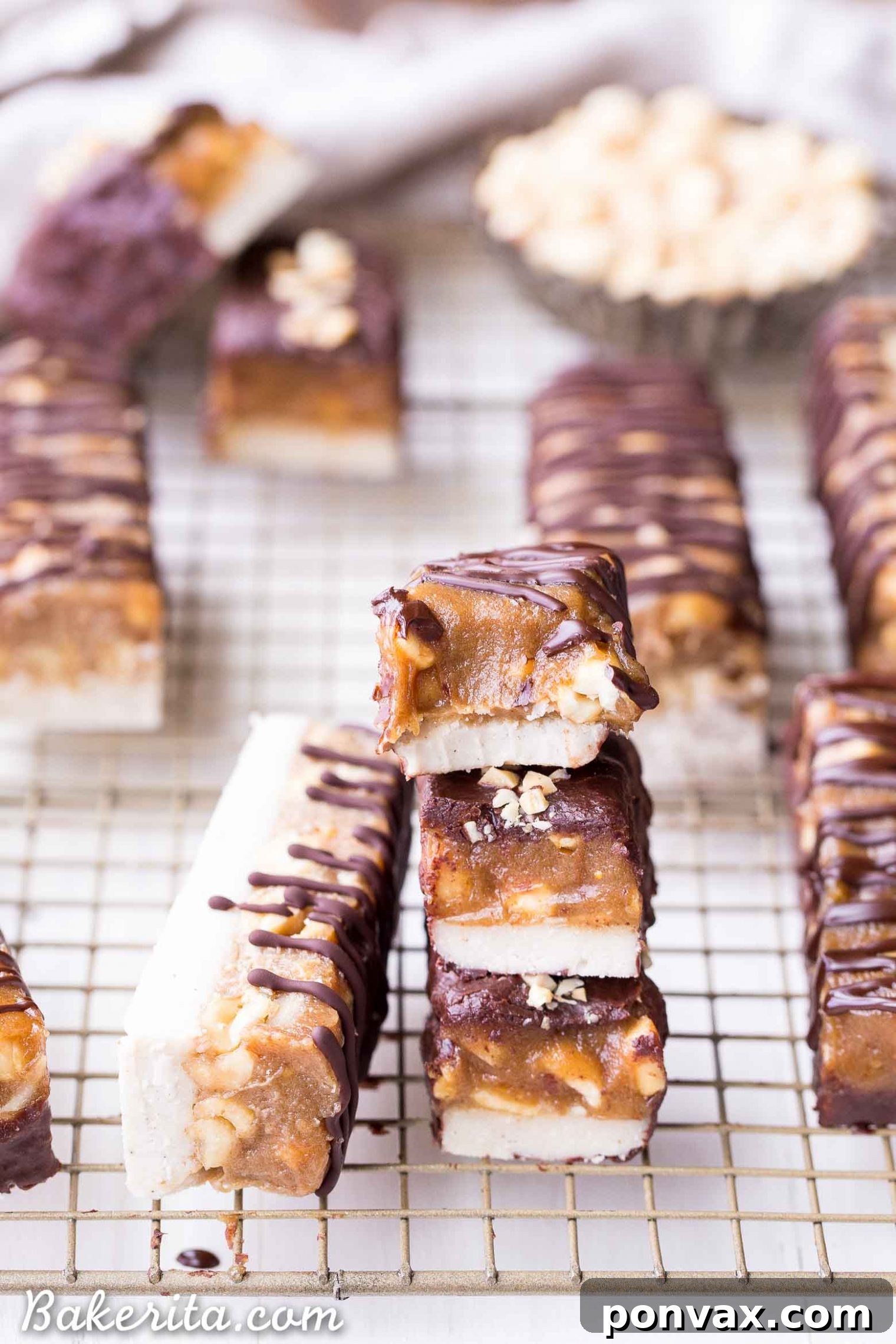 Close-up of a homemade Snickers bar cross-section, showing the distinct nougat, caramel, and peanut layers.