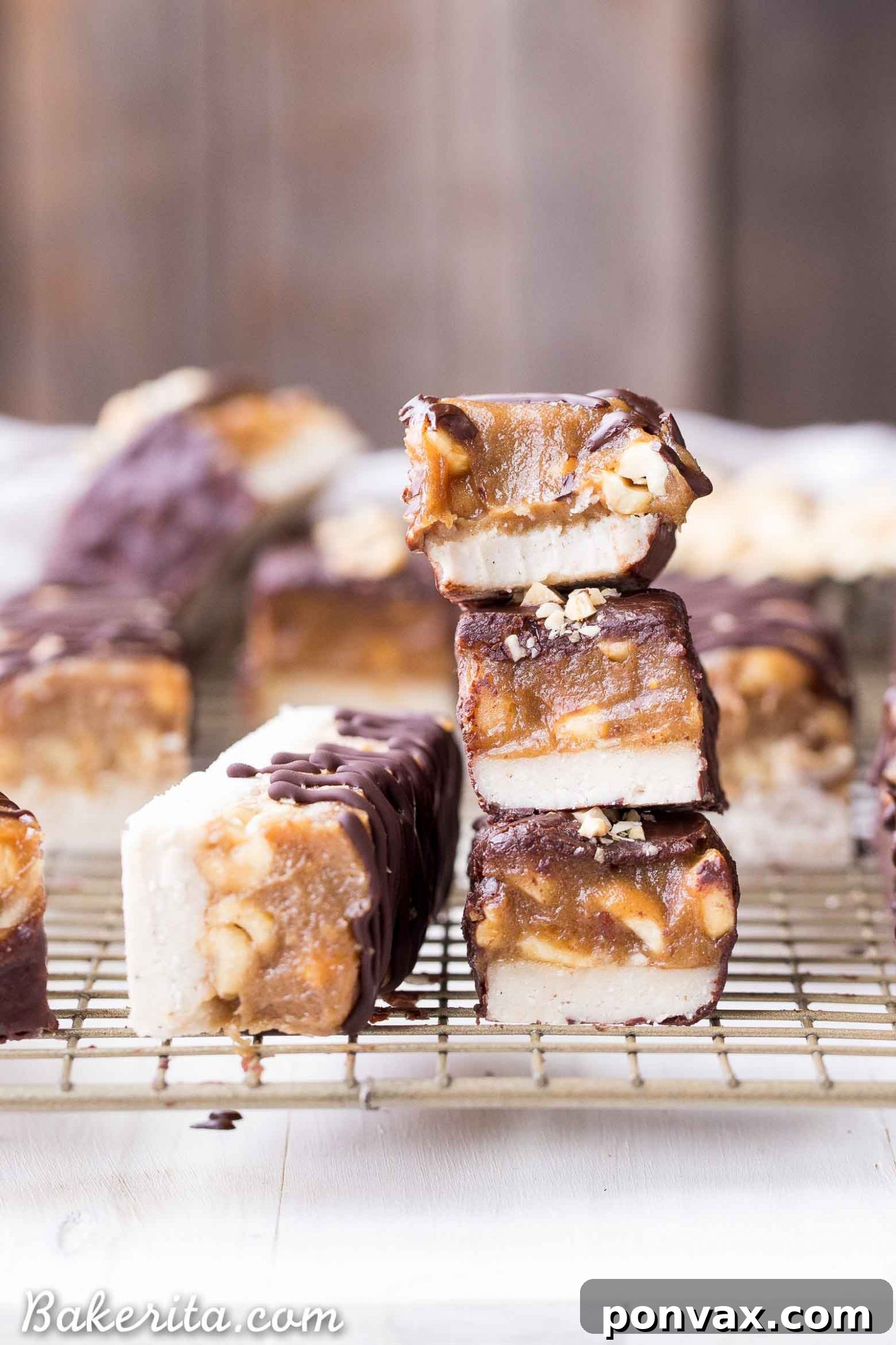 A freshly made batch of no-bake Snickers bars, showing the caramel and peanut layer before dipping in chocolate.