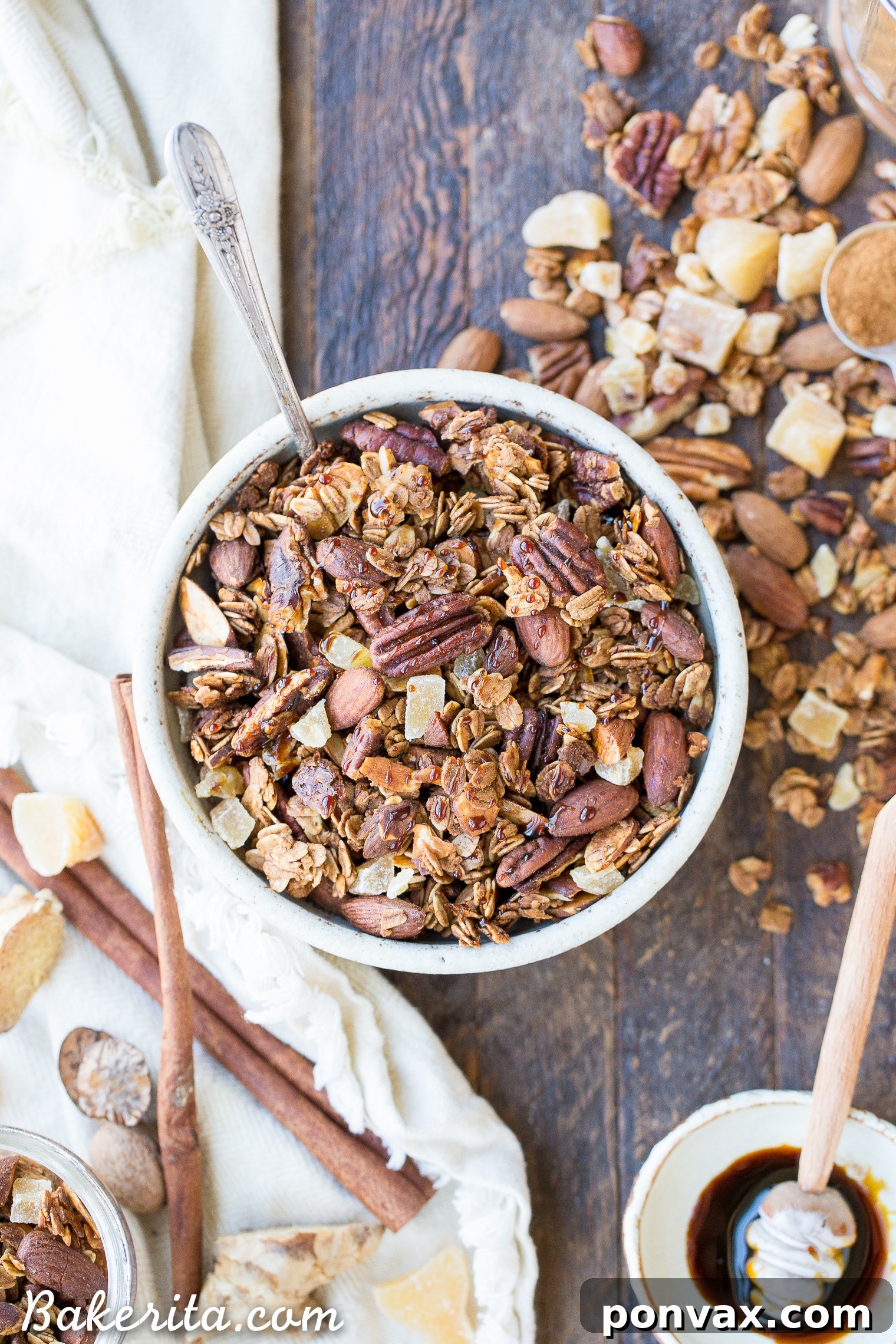 Gingerbread Spice Granola 4 Baking sheet filled with homemade Gingerbread Granola, ready for the oven, highlighting even distribution.