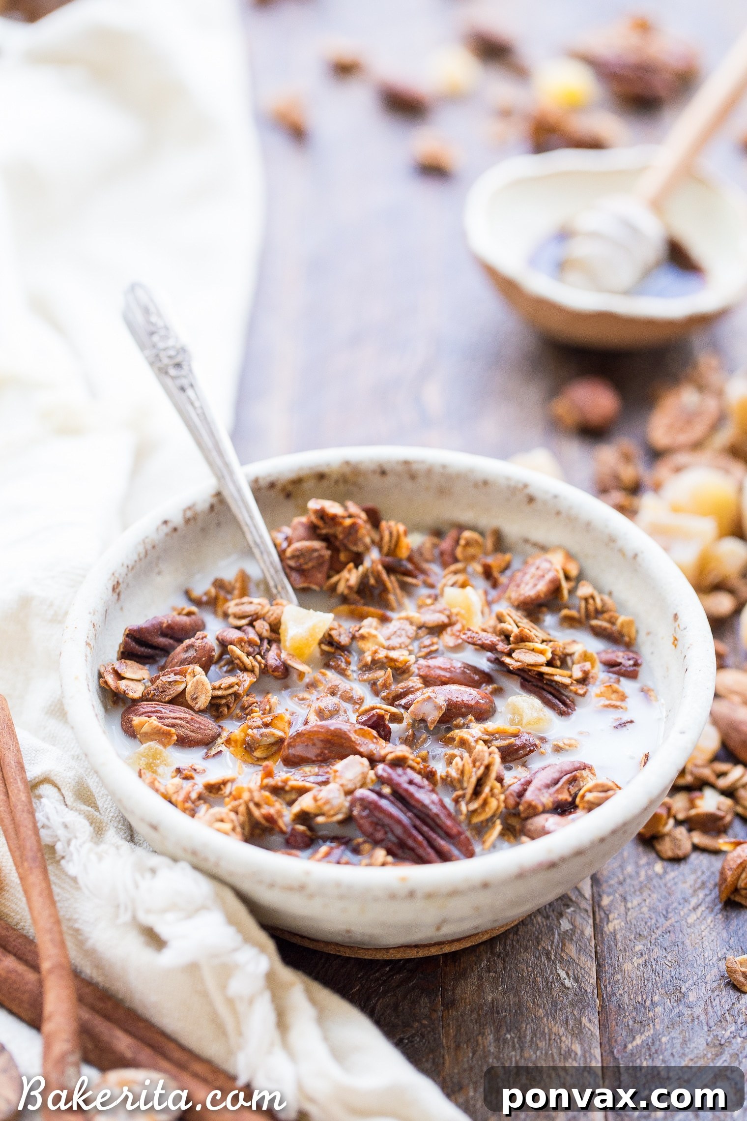 Gingerbread Spice Granola 5 Ingredients for Gingerbread Granola laid out on a baking sheet, featuring oats, nuts, and spices.