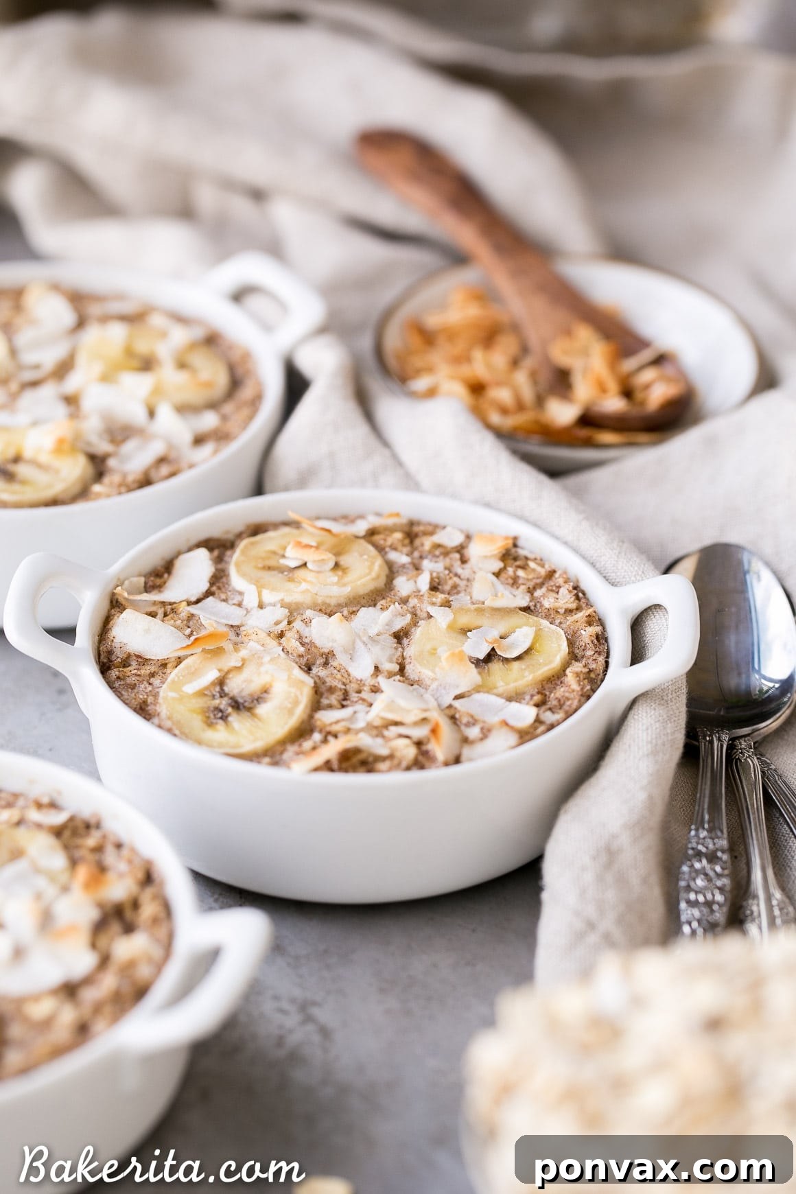 A trio of small ramekins filled with baked oatmeal, fresh out of the oven, demonstrating individual serving sizes.