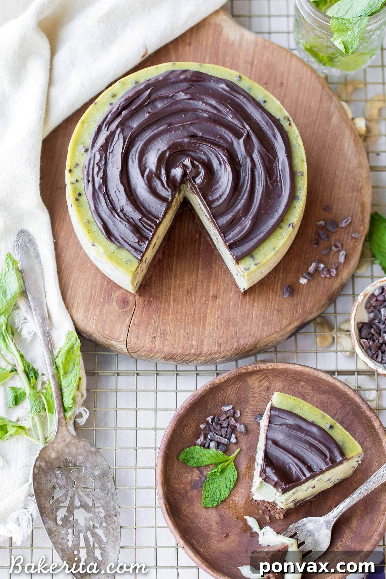 Paleo Vegan Gluten Free No Bake Mint Chip Cheesecake 3 A top-down view of a whole no-bake mint chip cheesecake, showcasing its green filling, chocolate nibs, and glossy dark chocolate ganache.