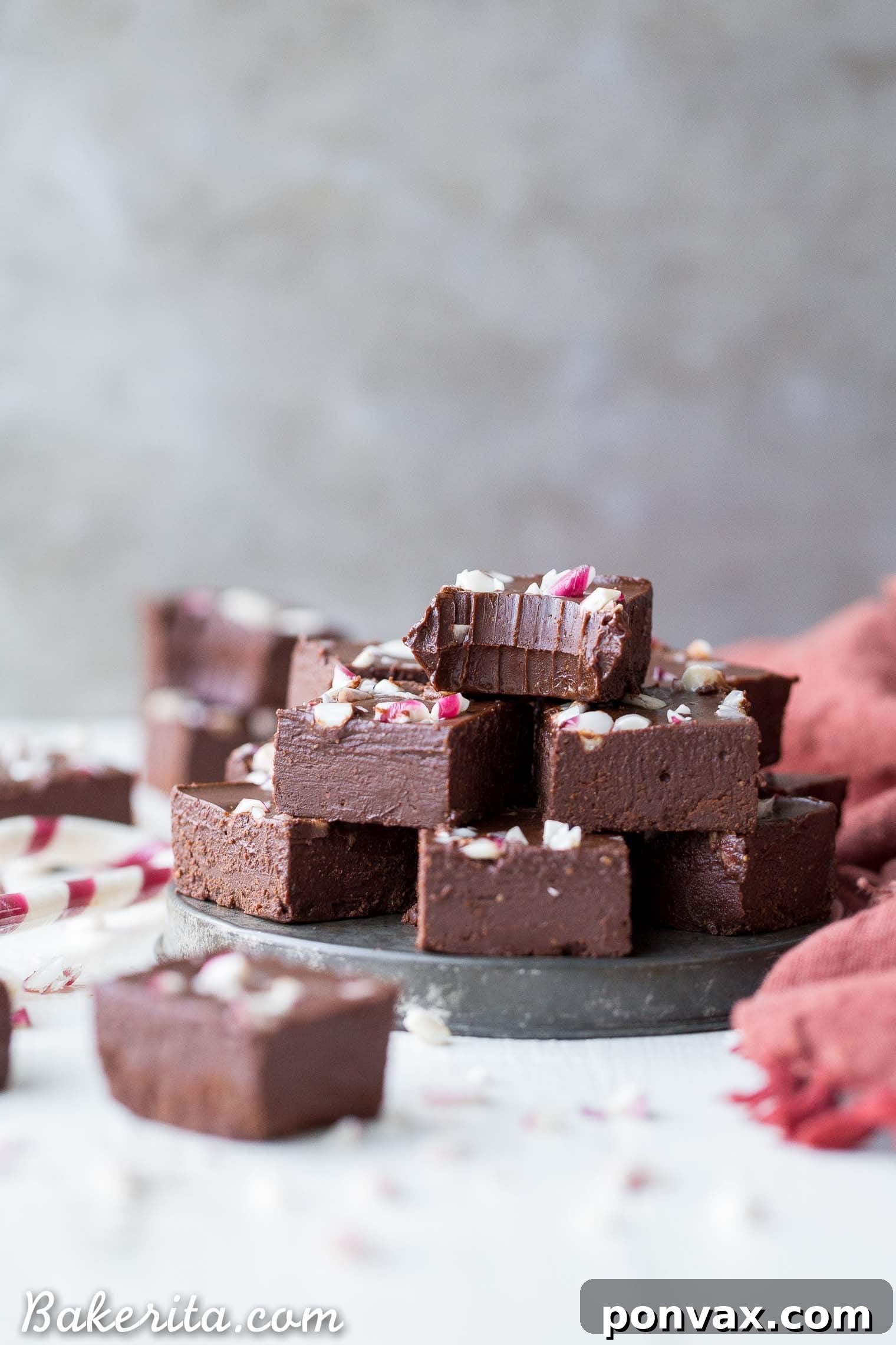 Refreshing Vegan Chocolate Peppermint Fudge 6 Stack of vegan chocolate peppermint fudge pieces with green and red sprinkles.