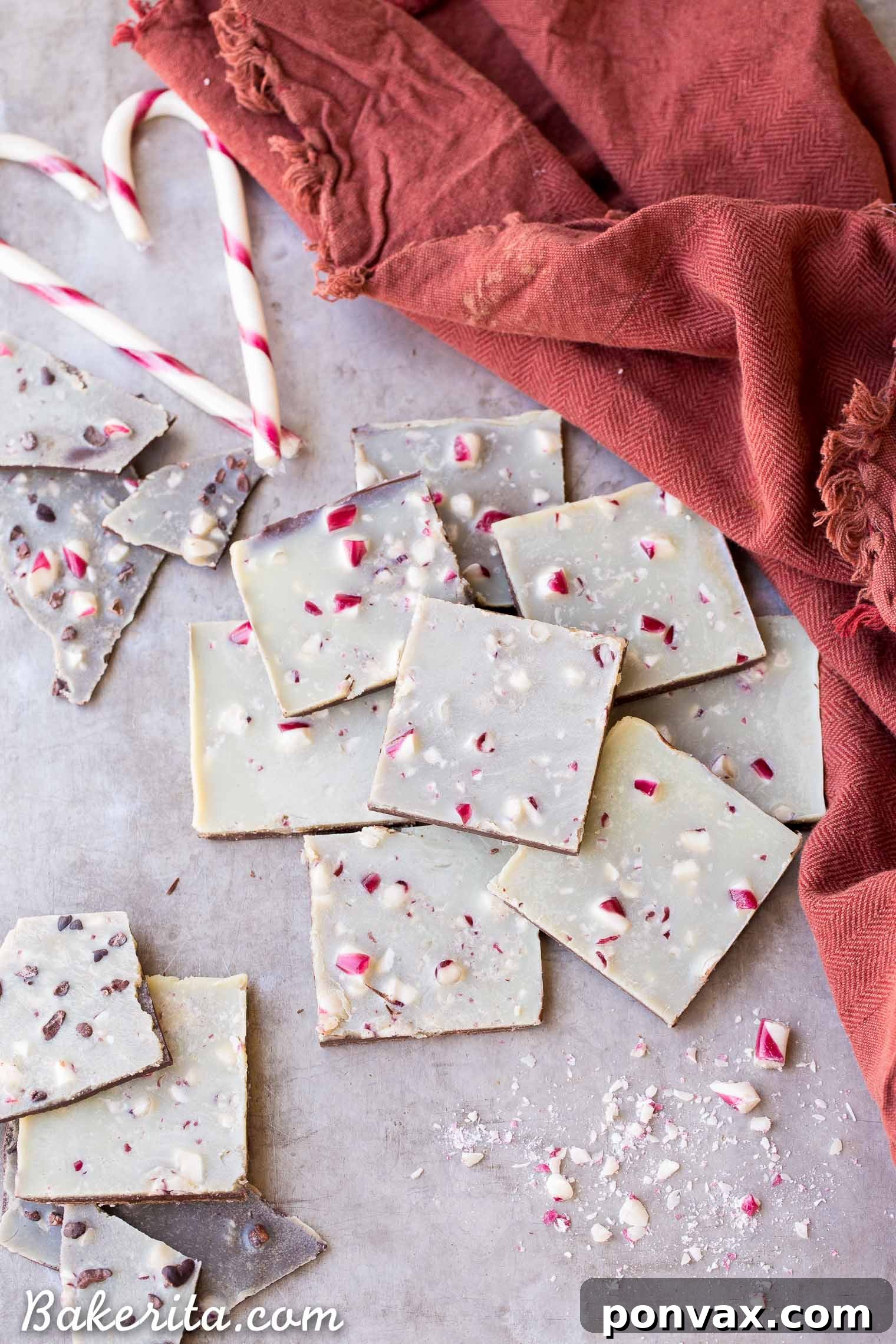 A stunning close-up of Vegan Chocolate Peppermint Bark, showcasing layers of dark and white chocolate with vibrant red peppermint pieces. This healthier twist on the classic holiday treat is gluten-free, paleo, and vegan, perfect for guilt-free indulgence.