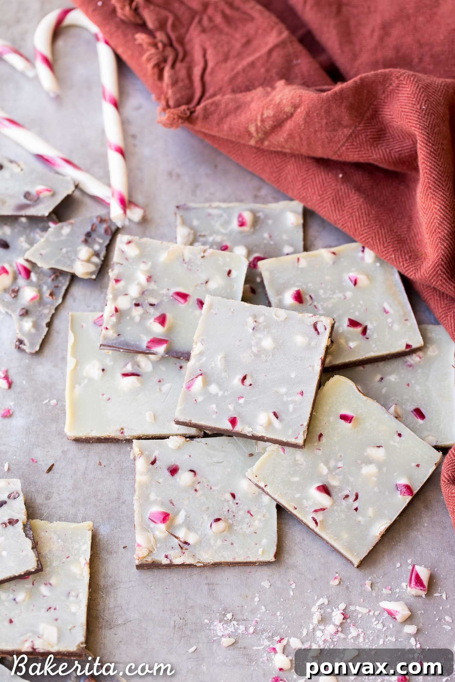 The delicious moment of pouring the homemade vegan white chocolate over the dark chocolate layer, a crucial step in making this healthier peppermint bark. The smooth, glistening white chocolate is about to be topped with crushed peppermint candies.