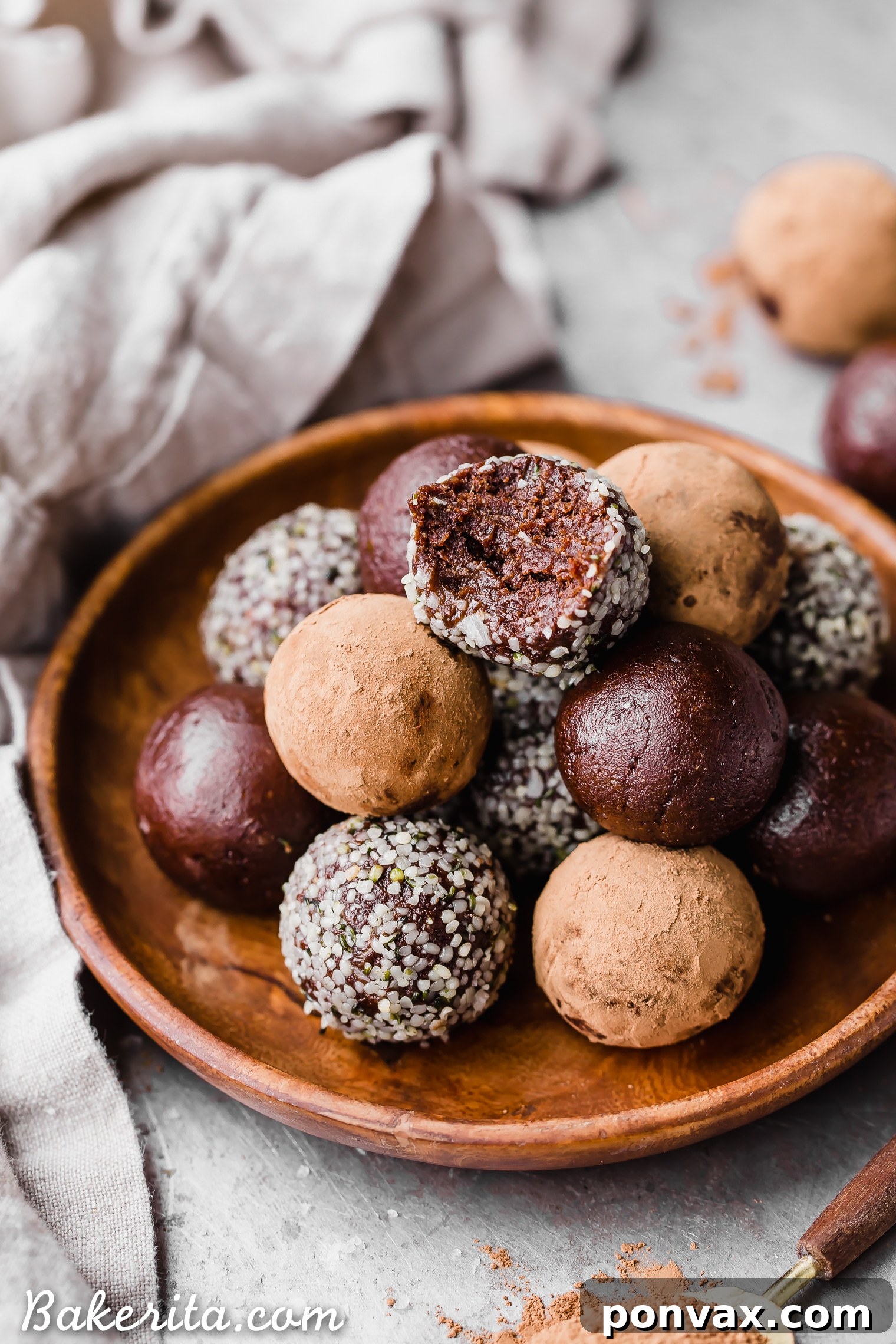 A batch of freshly made Raw Chocolate Truffles, coated in hemp seeds and cacao, ready for enjoyment. Gluten-free, paleo, and vegan.
