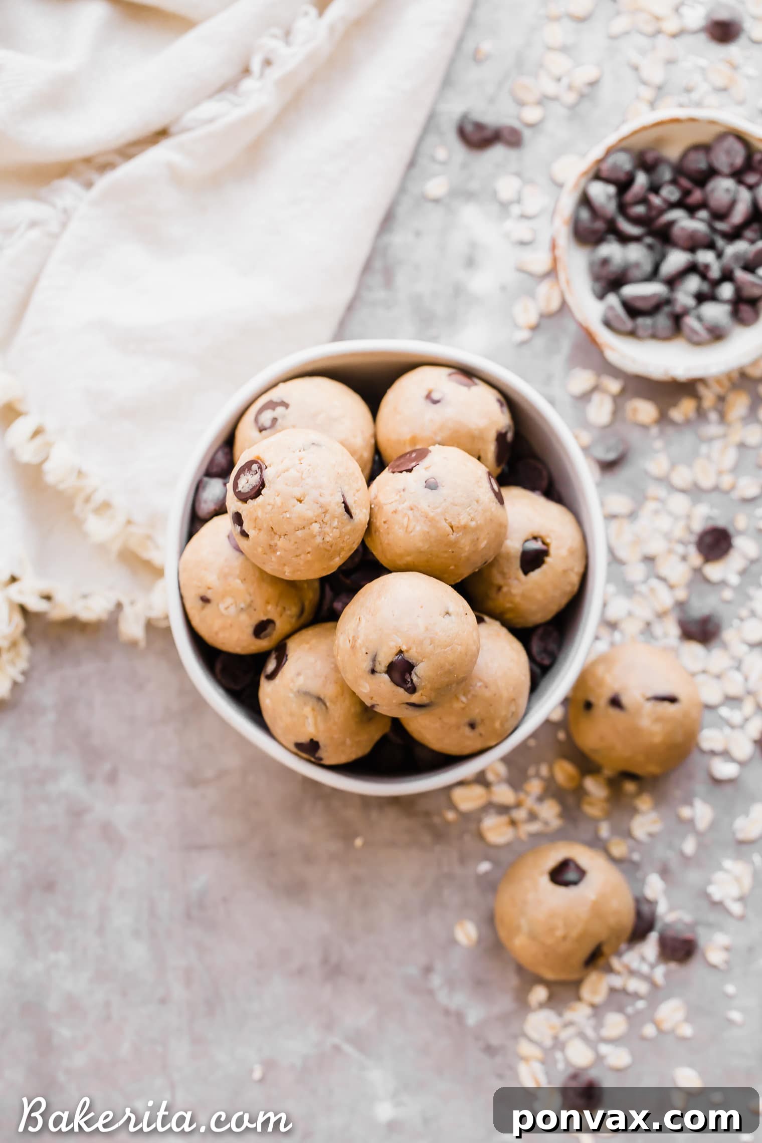 Oatmeal Chocolate Chip Cookie Dough Bites: Gluten Free & Vegan. Stacked in a bowl with oats and chocolate chips.