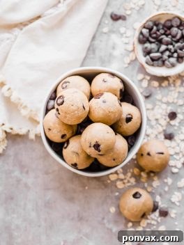 Oatmeal Chocolate Chip Cookie Dough Bites: Gluten Free & Vegan. Stacked in a bowl with oats and chocolate chips.