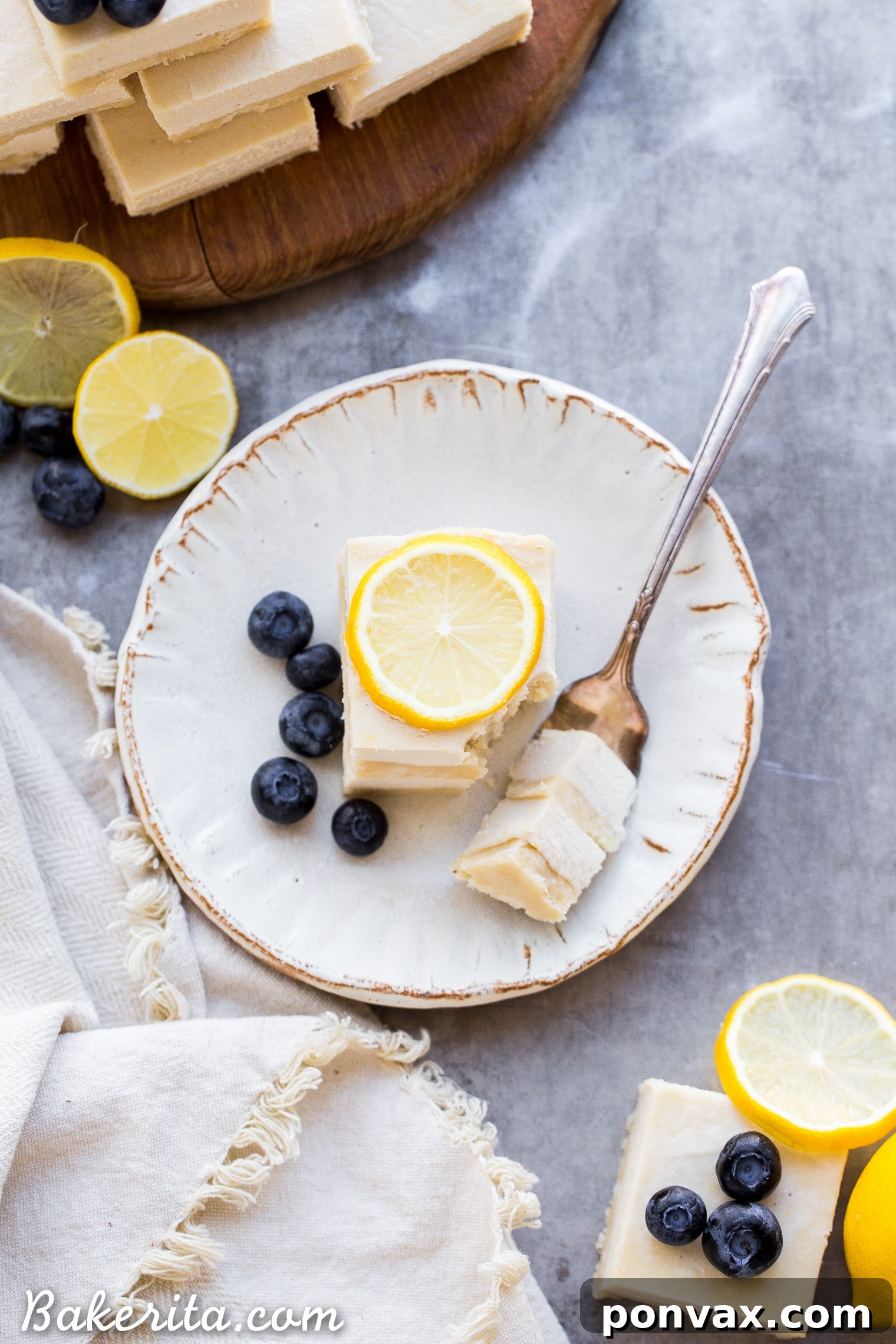 Zesty Vegan No-Bake Lemon Bars 6 Hand holding a perfect square of No-Bake Vegan Lemon Bar, showing the creamy texture.