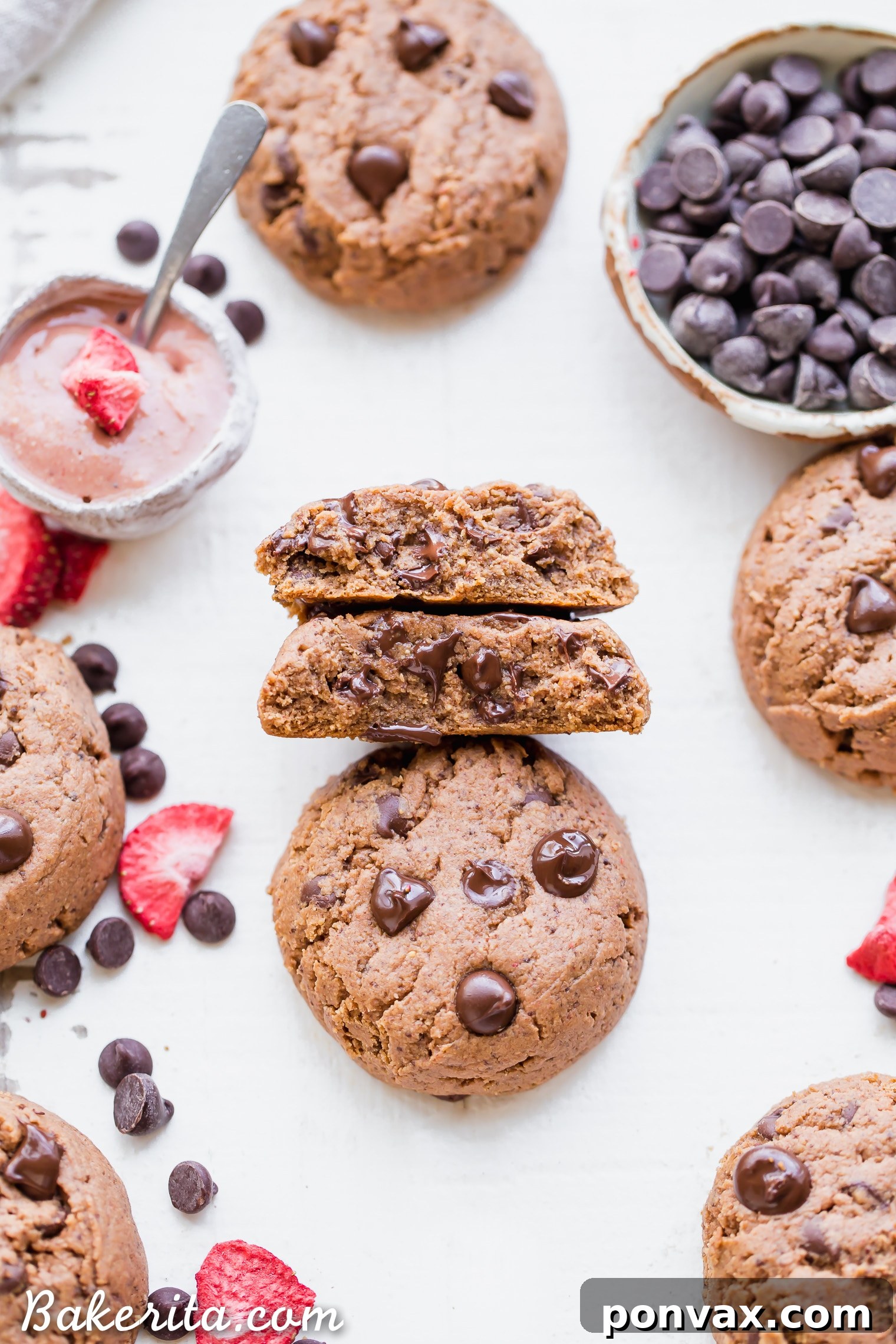 Ingredients for Flourless Strawberry Chocolate Chip Cookies laid out: cashew butter, coconut sugar, egg, baking soda, freeze-dried strawberries, and chocolate chips.