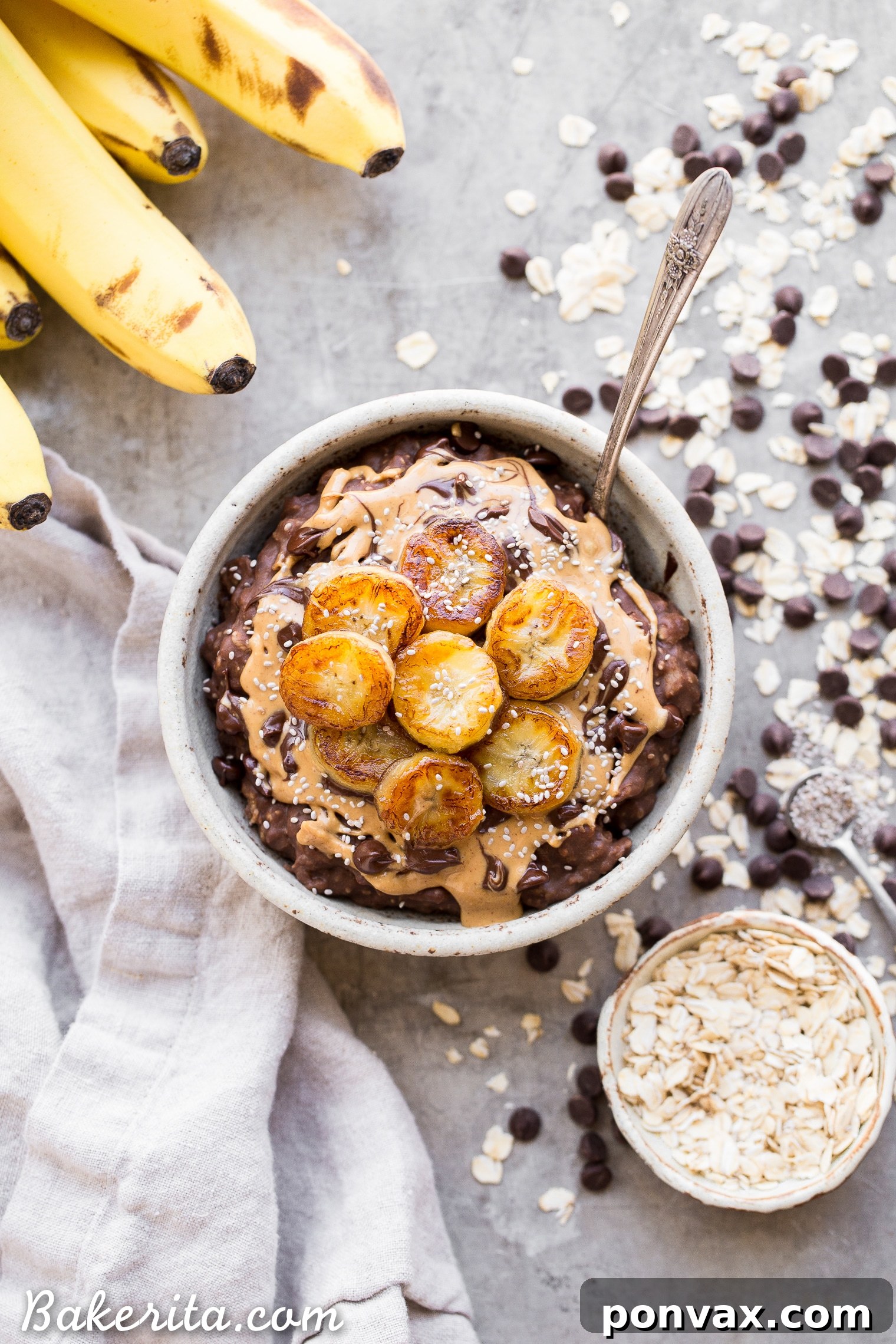A bowl of Chocolate Banana Oatmeal, garnished with perfectly caramelized banana slices and dark chocolate chips.
