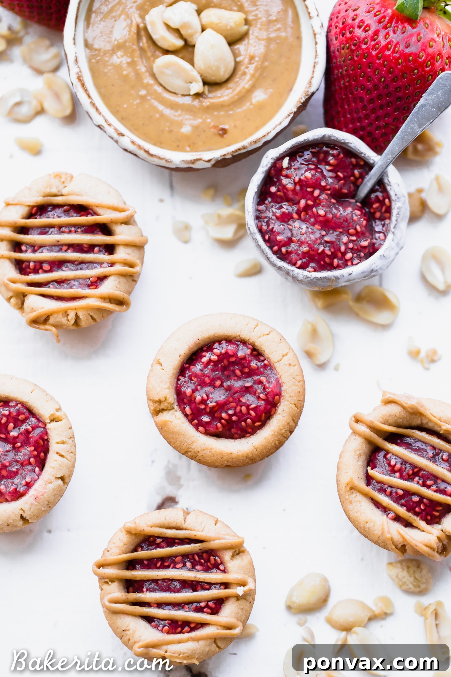 Strawberry chia jam filling being added to a baked peanut butter tartlet crust.